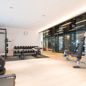 a room with exercise equipment and a large wall