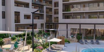 a courtyard with chairs and umbrellas in front of a building