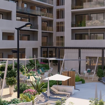 a courtyard with chairs and umbrellas in front of a building