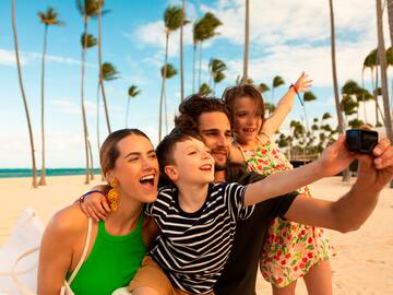 a group of people posing for a picture on a beach