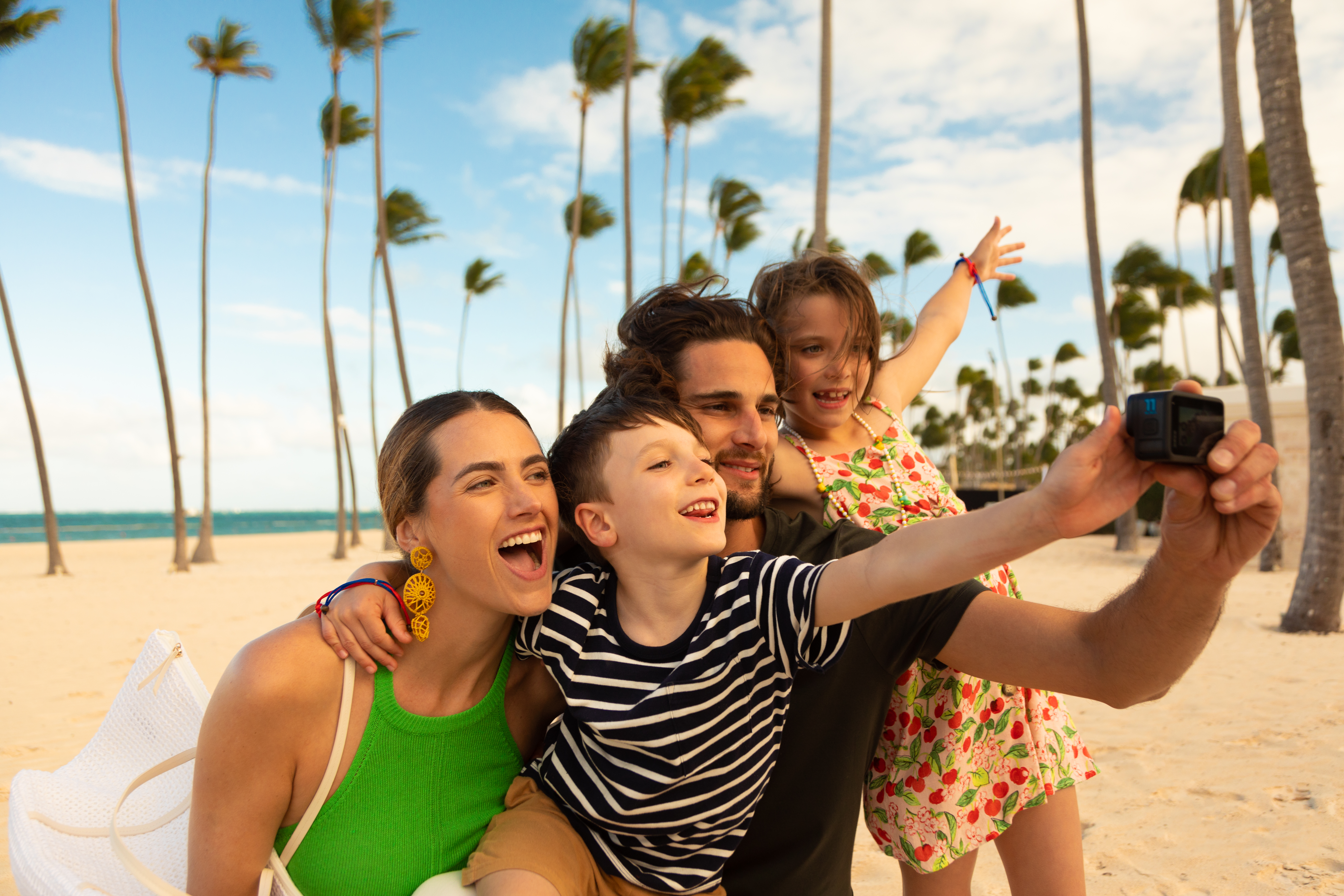 a group of people posing for a picture on a beach