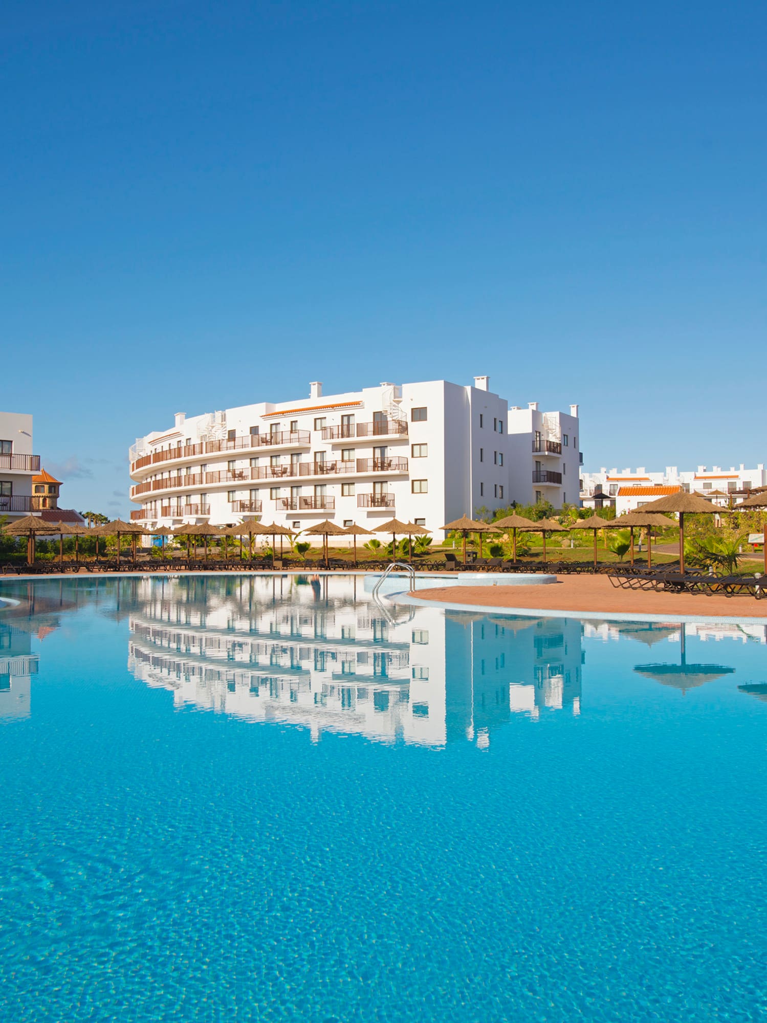 a pool with buildings in the background
