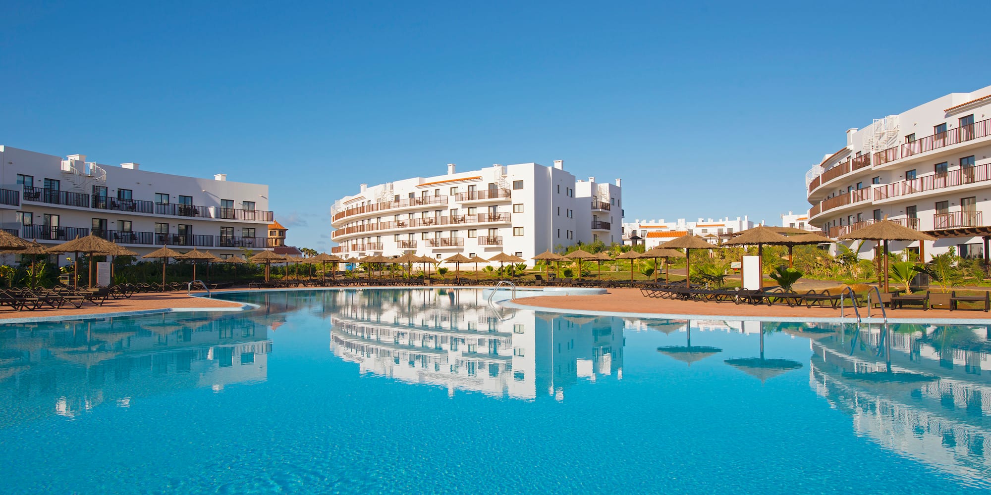 a pool with buildings in the background
