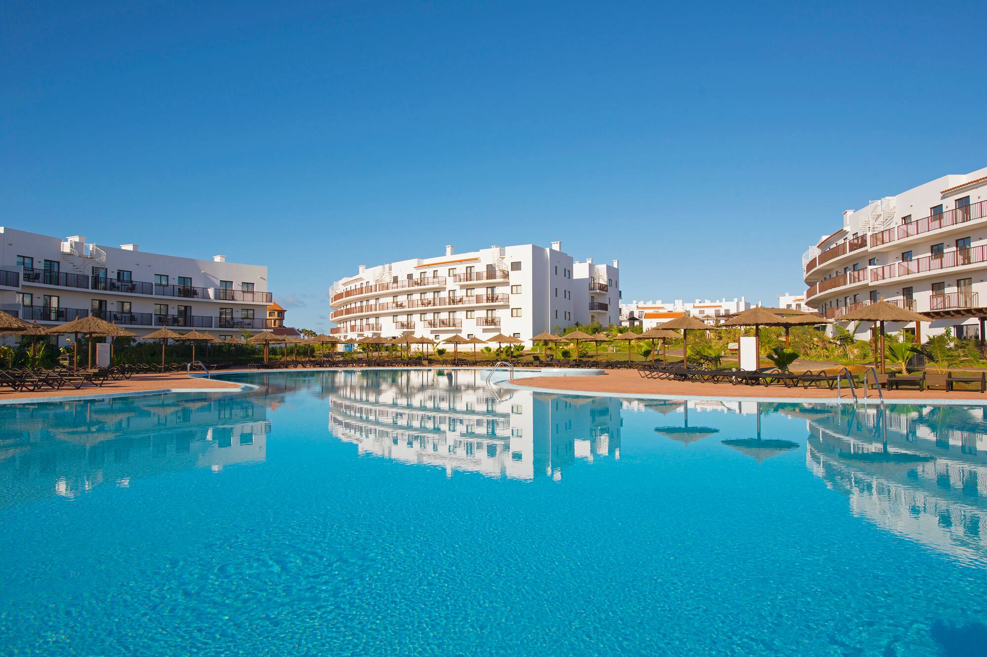 a pool with buildings in the background