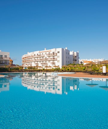 a pool with buildings in the background