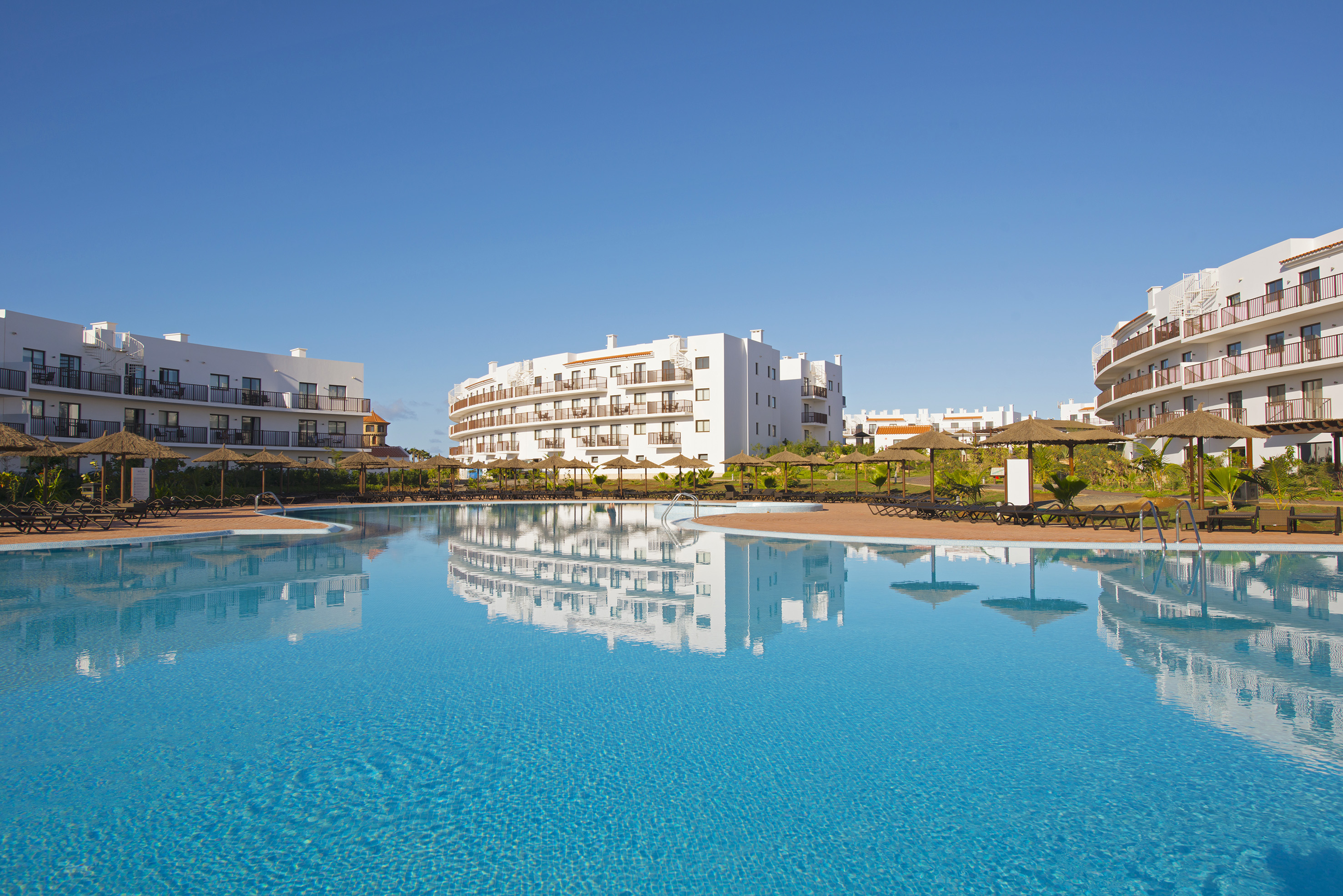 a pool with buildings in the background