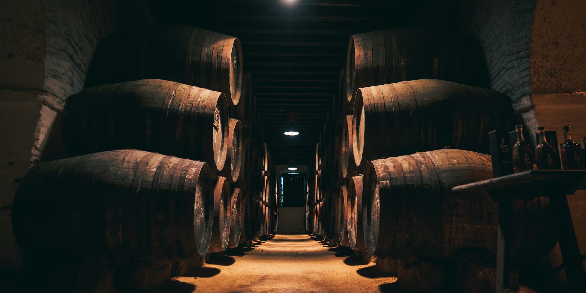 a row of barrels in a dark room