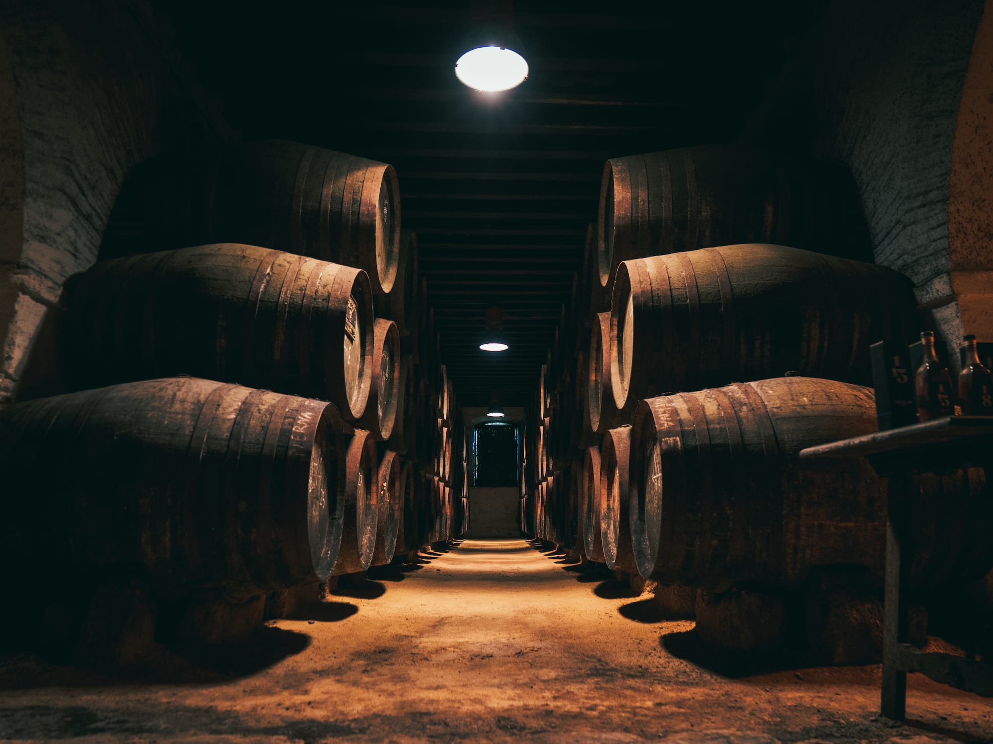 a row of barrels in a dark room