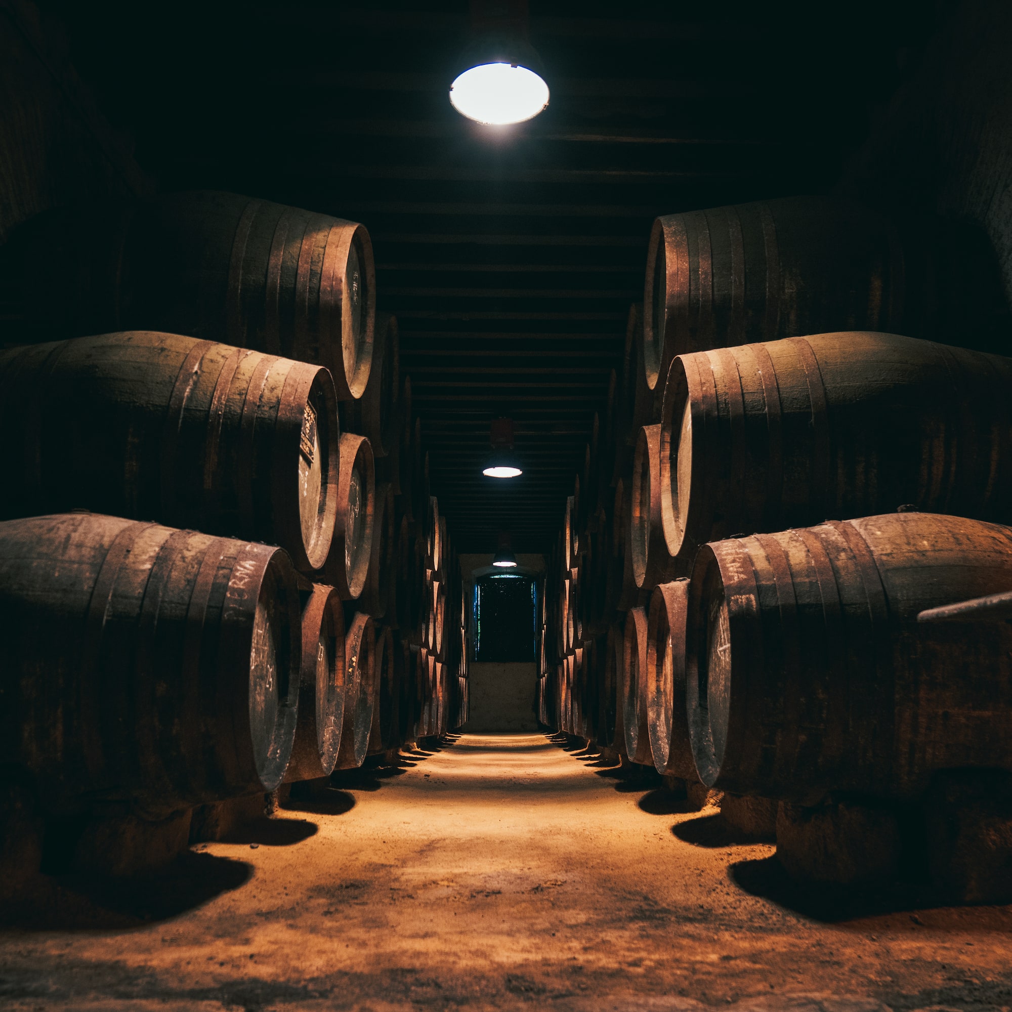 a row of barrels in a dark room