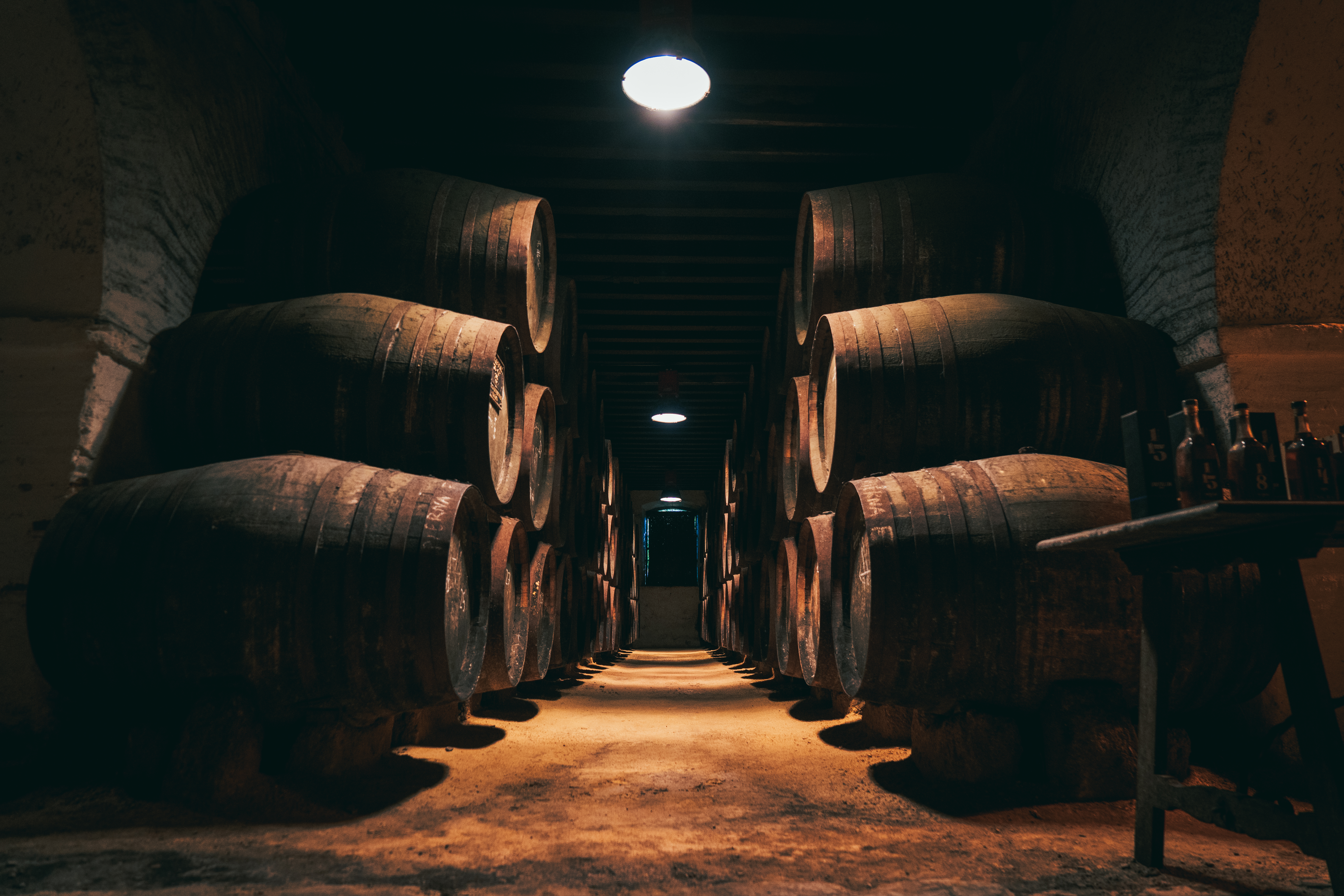 a row of barrels in a dark room