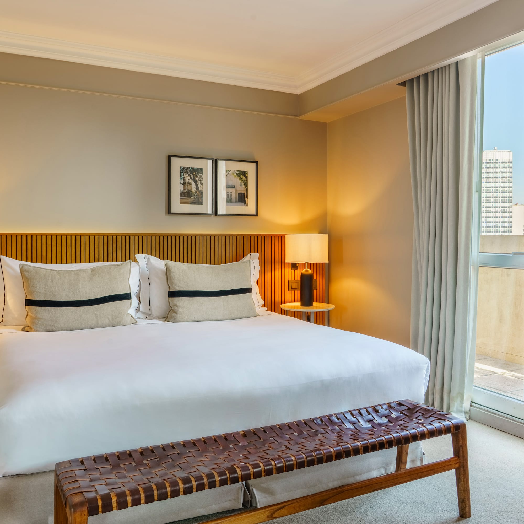 a bed with a bench and a window