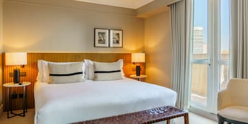 a bed with a bench and a window