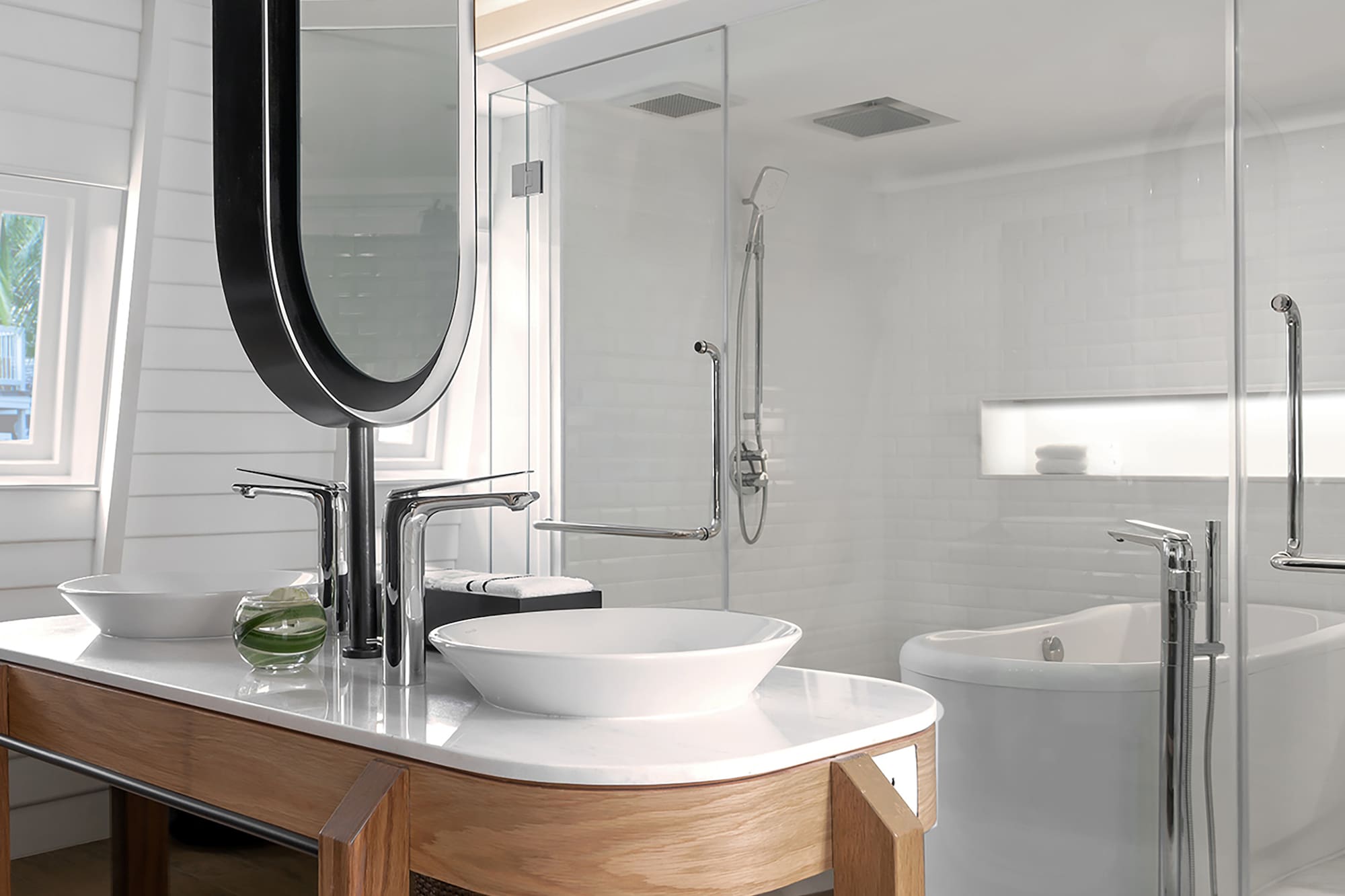 a bathroom with a large mirror and a tub