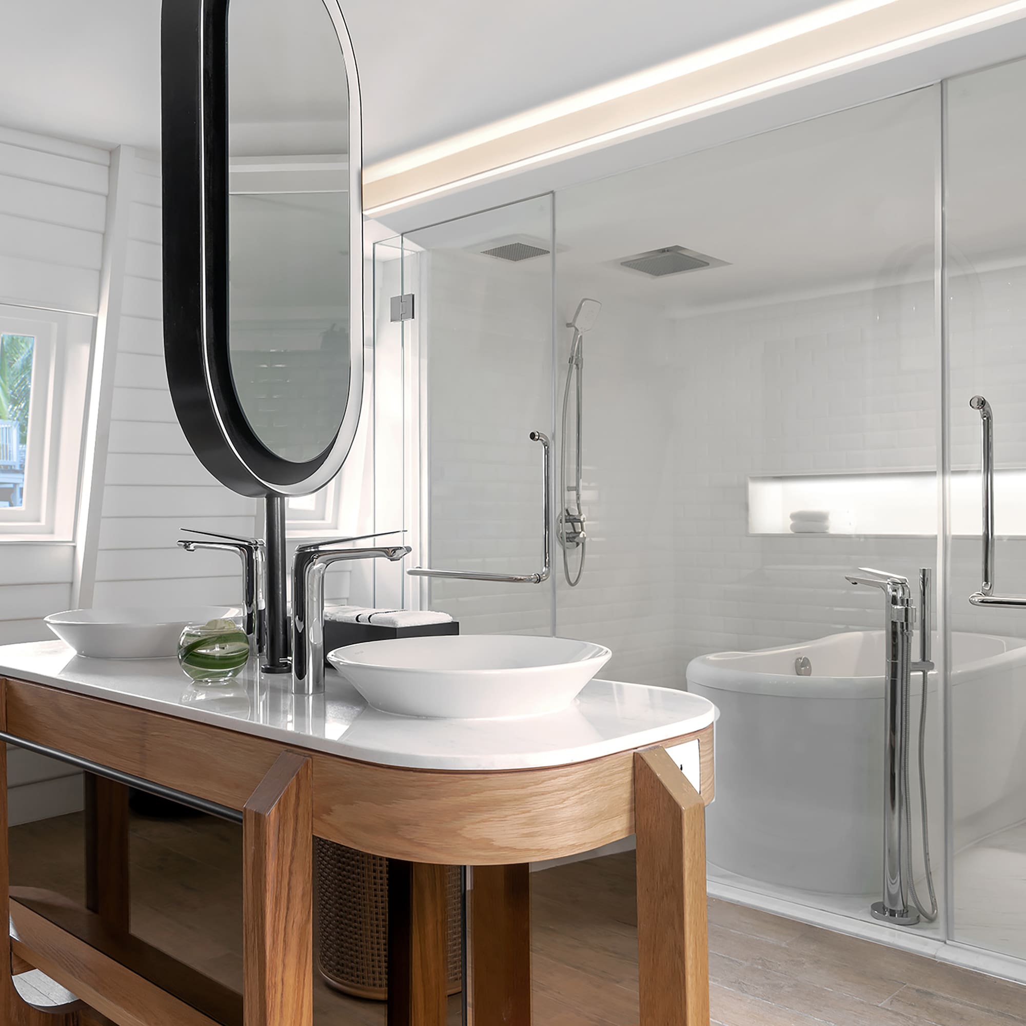 a bathroom with a large mirror and a tub