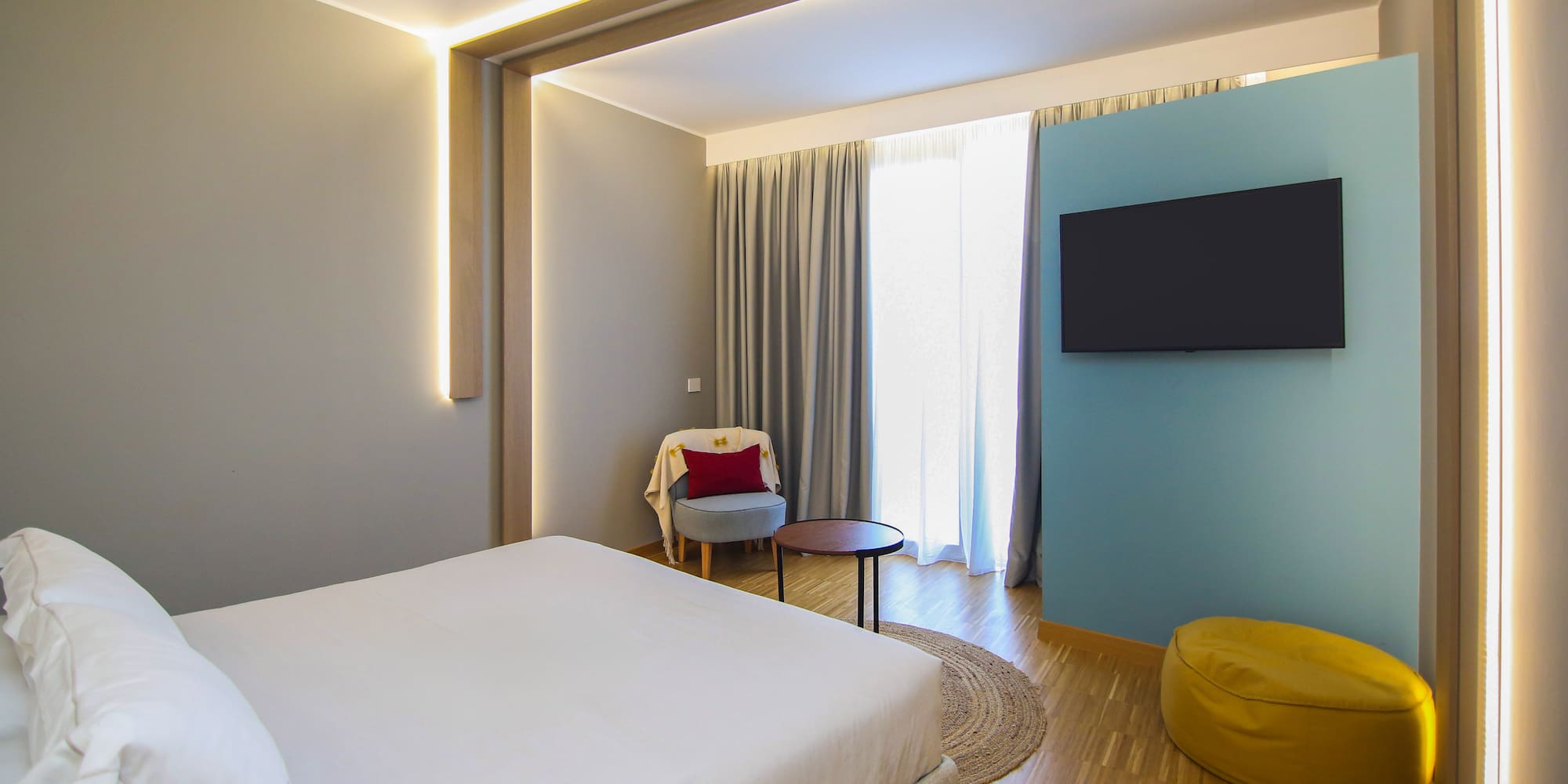 a room with a bed and a tv