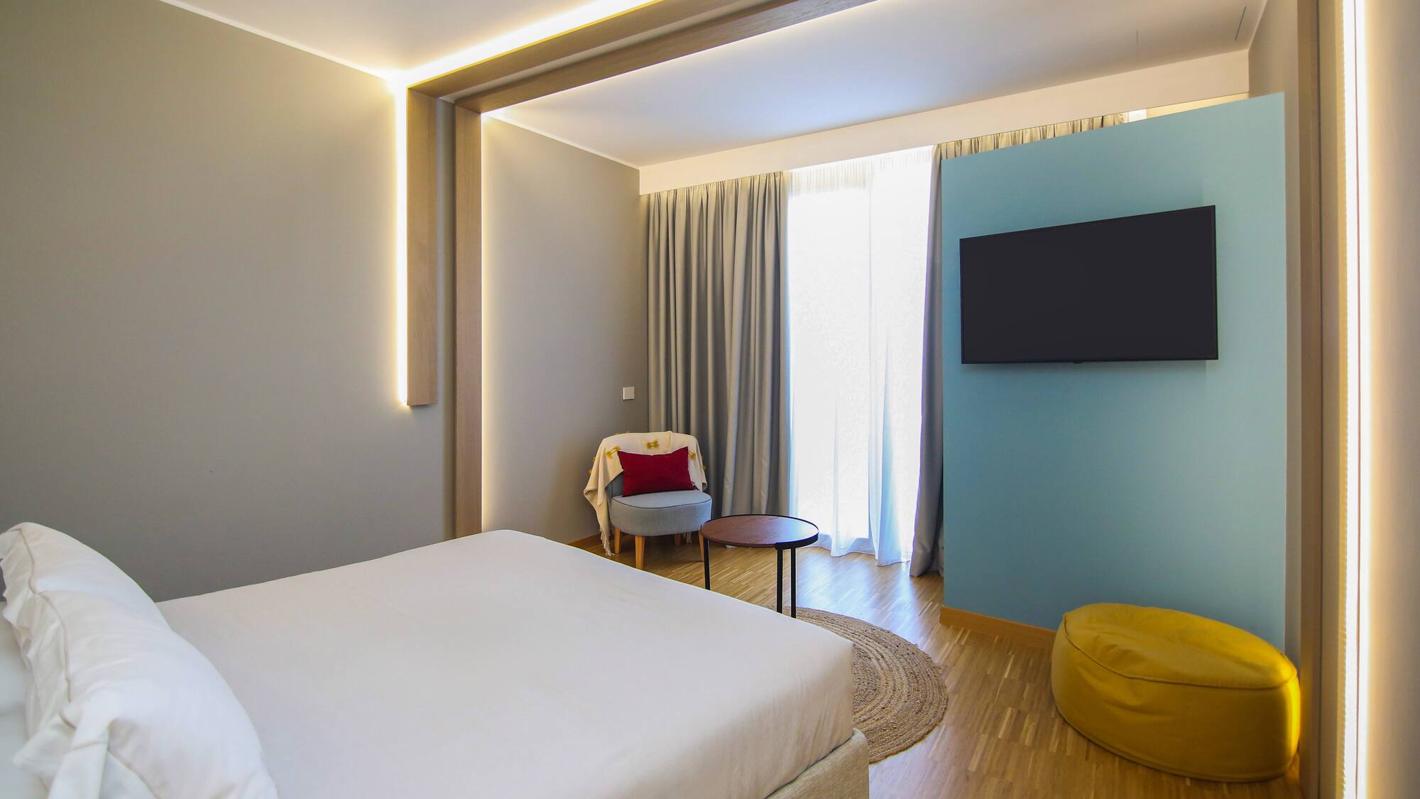 a room with a bed and a tv