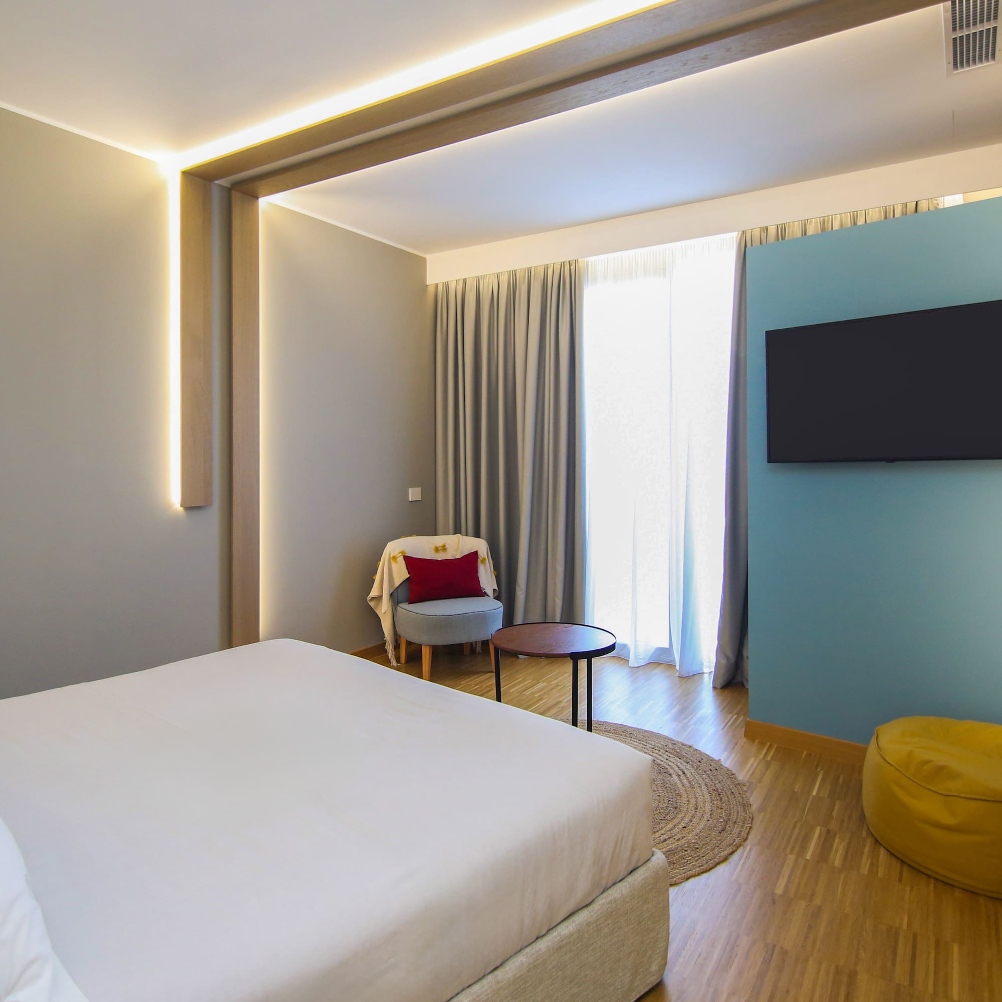 a room with a bed and a tv