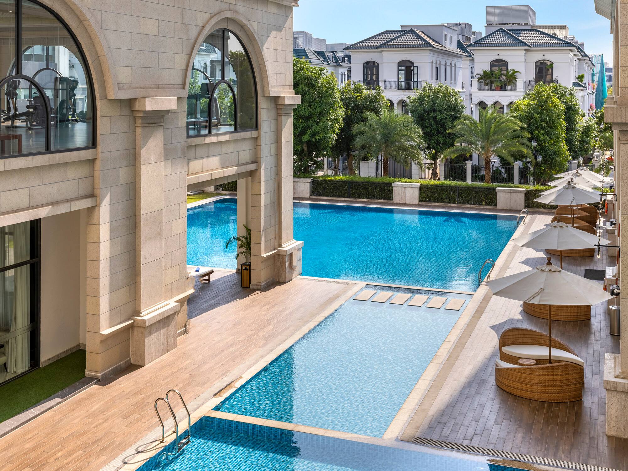 a swimming pool with a building and trees