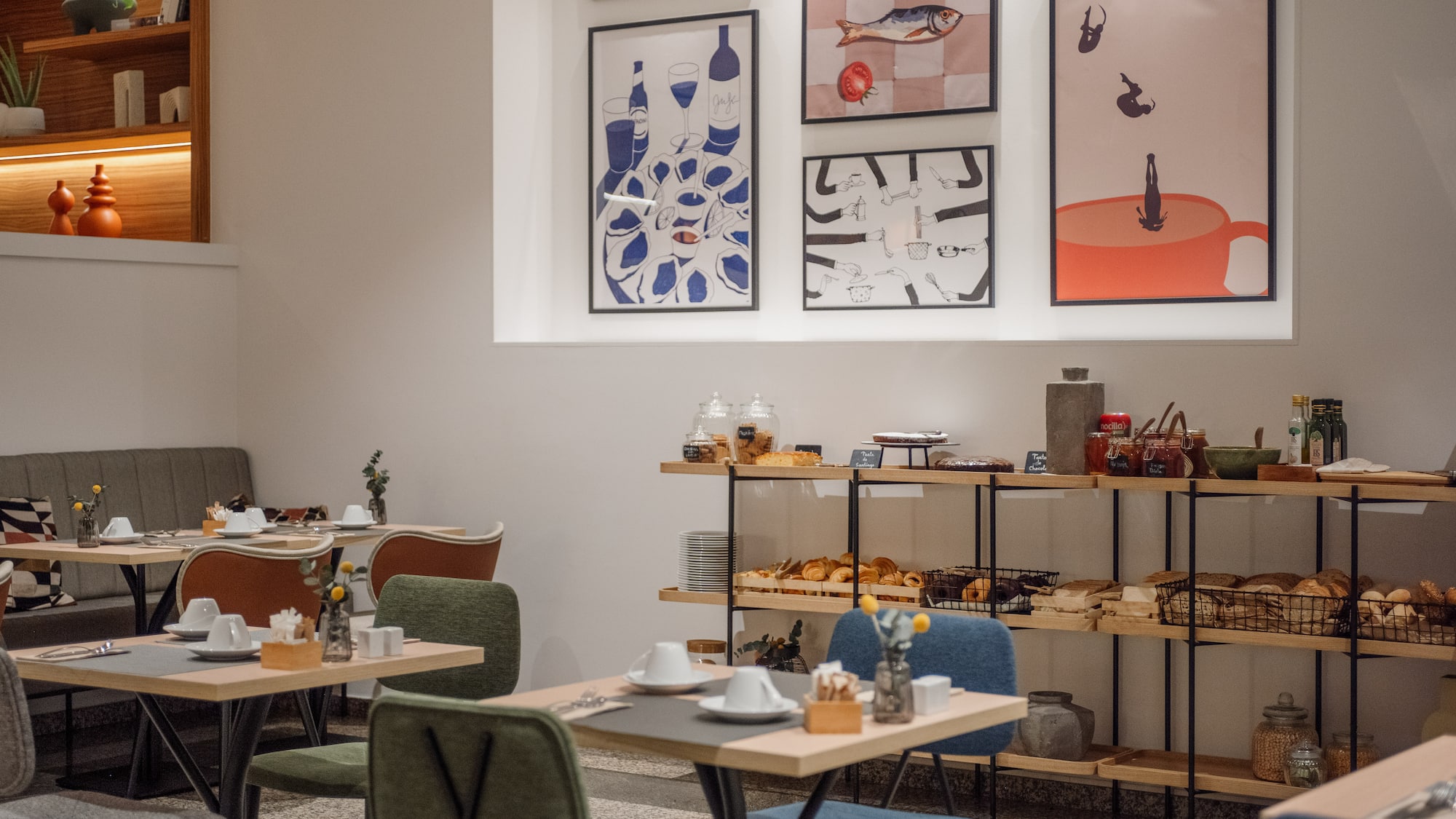 a room with tables and chairs and art on the wall