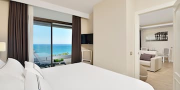 a bedroom with a view of the ocean