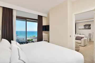 a bedroom with a view of the ocean