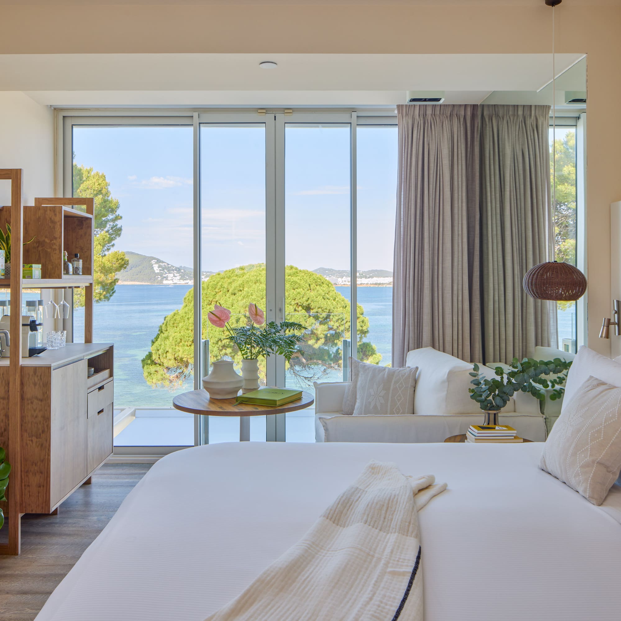 Modern hotel room with stunning sea view, king bed, and contemporary decor.