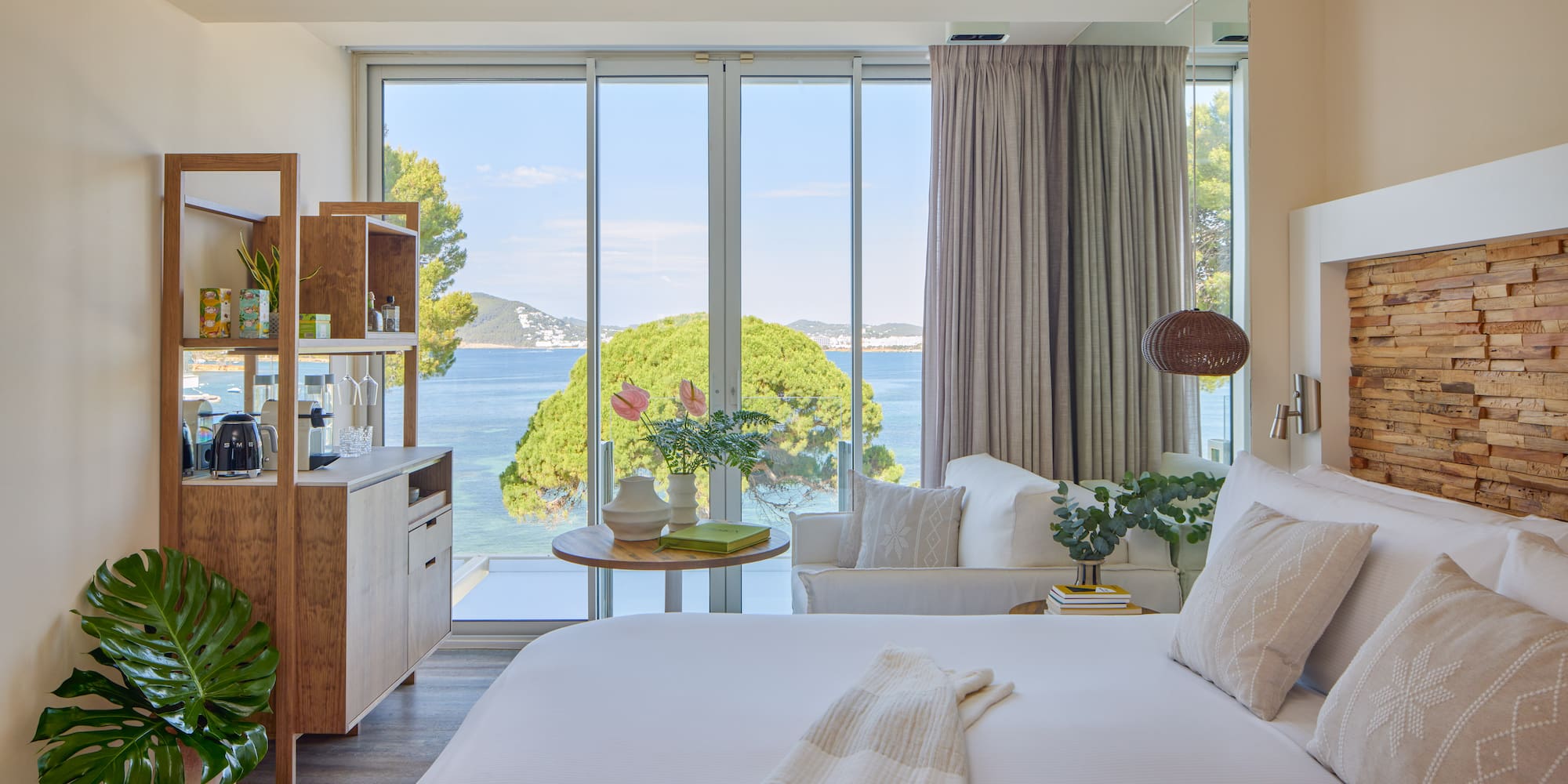 Modern hotel room with stunning sea view, king bed, and contemporary decor.