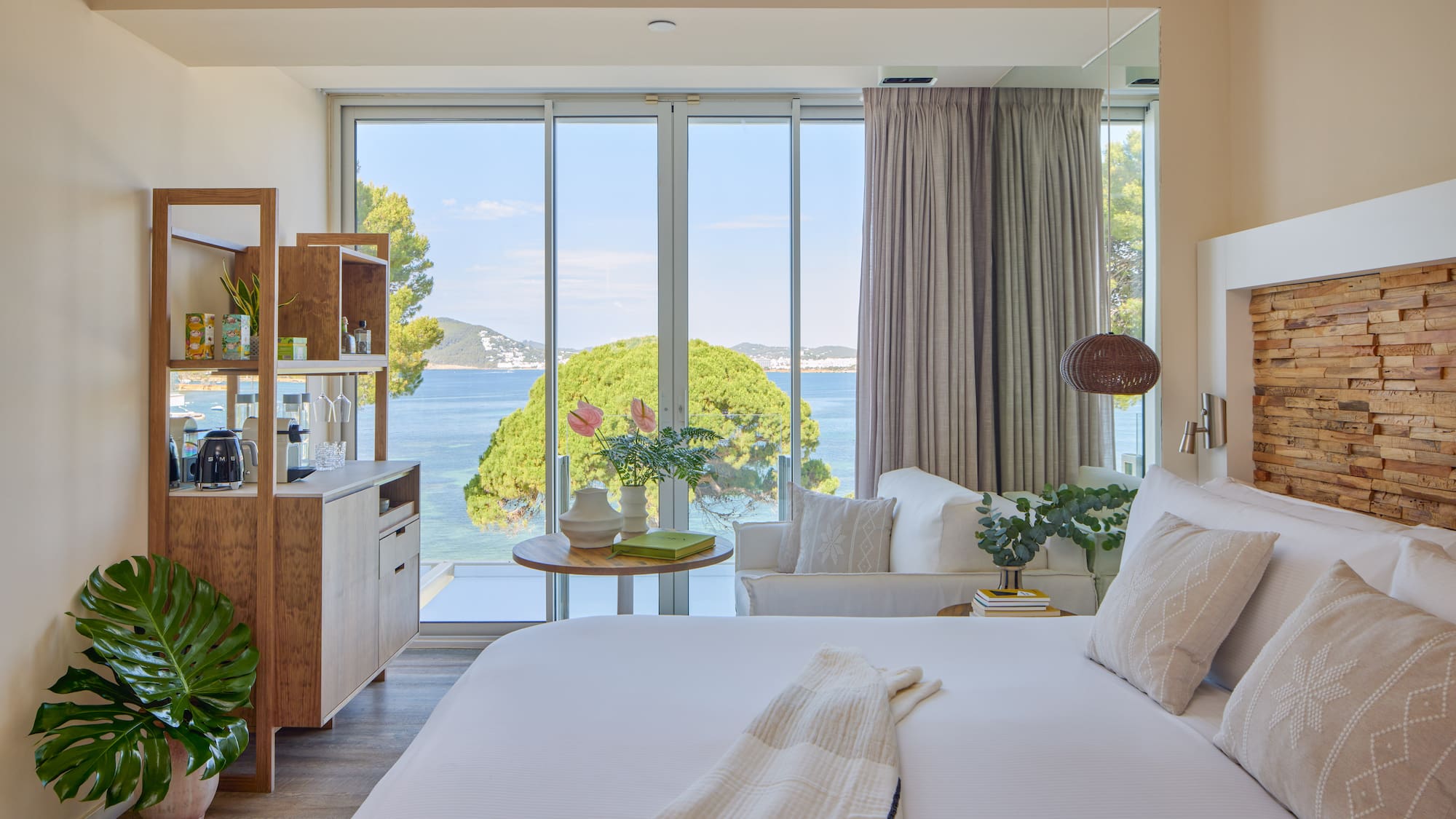 Modern hotel room with stunning sea view, king bed, and contemporary decor.