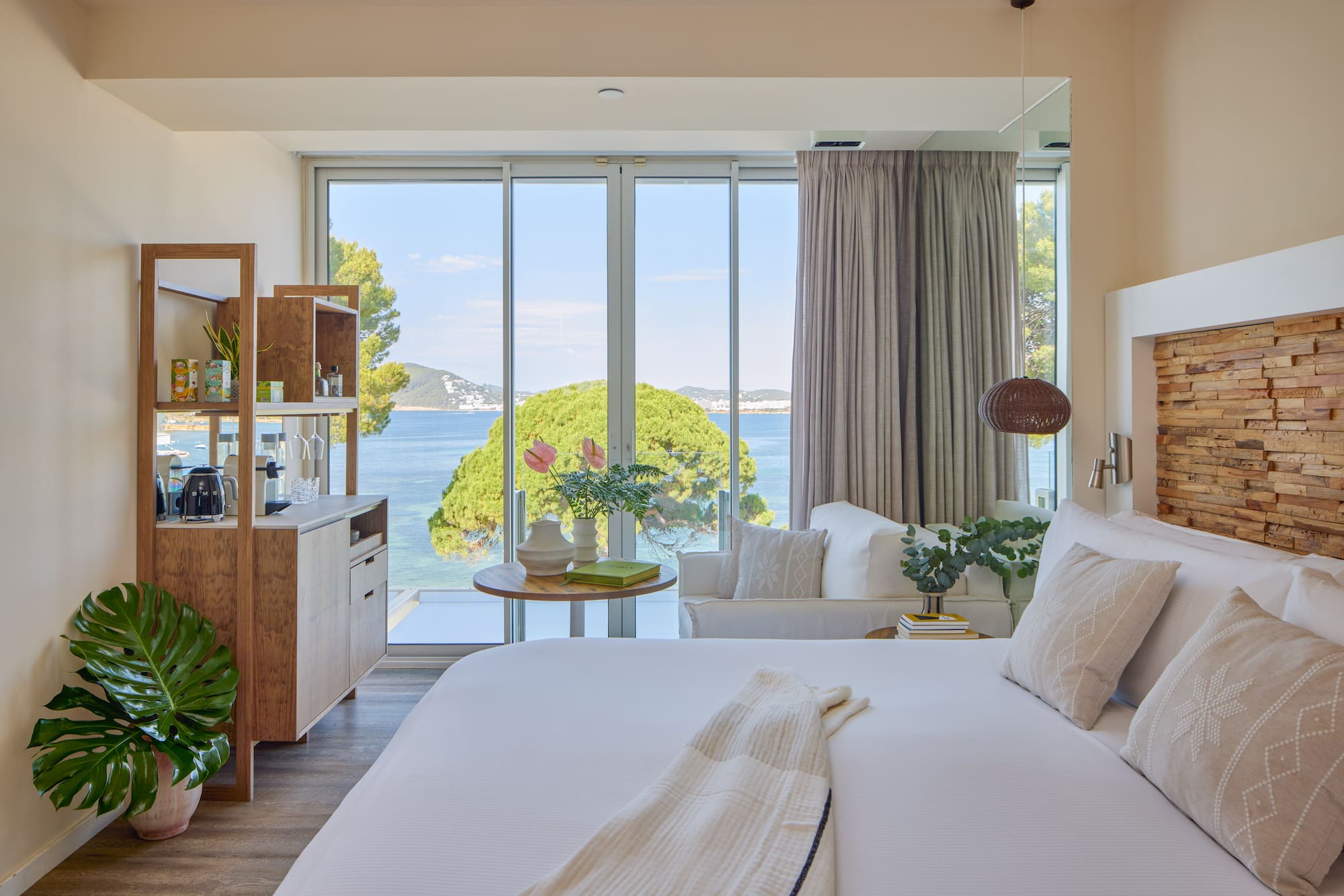 Modern hotel room with stunning sea view, king bed, and contemporary decor.