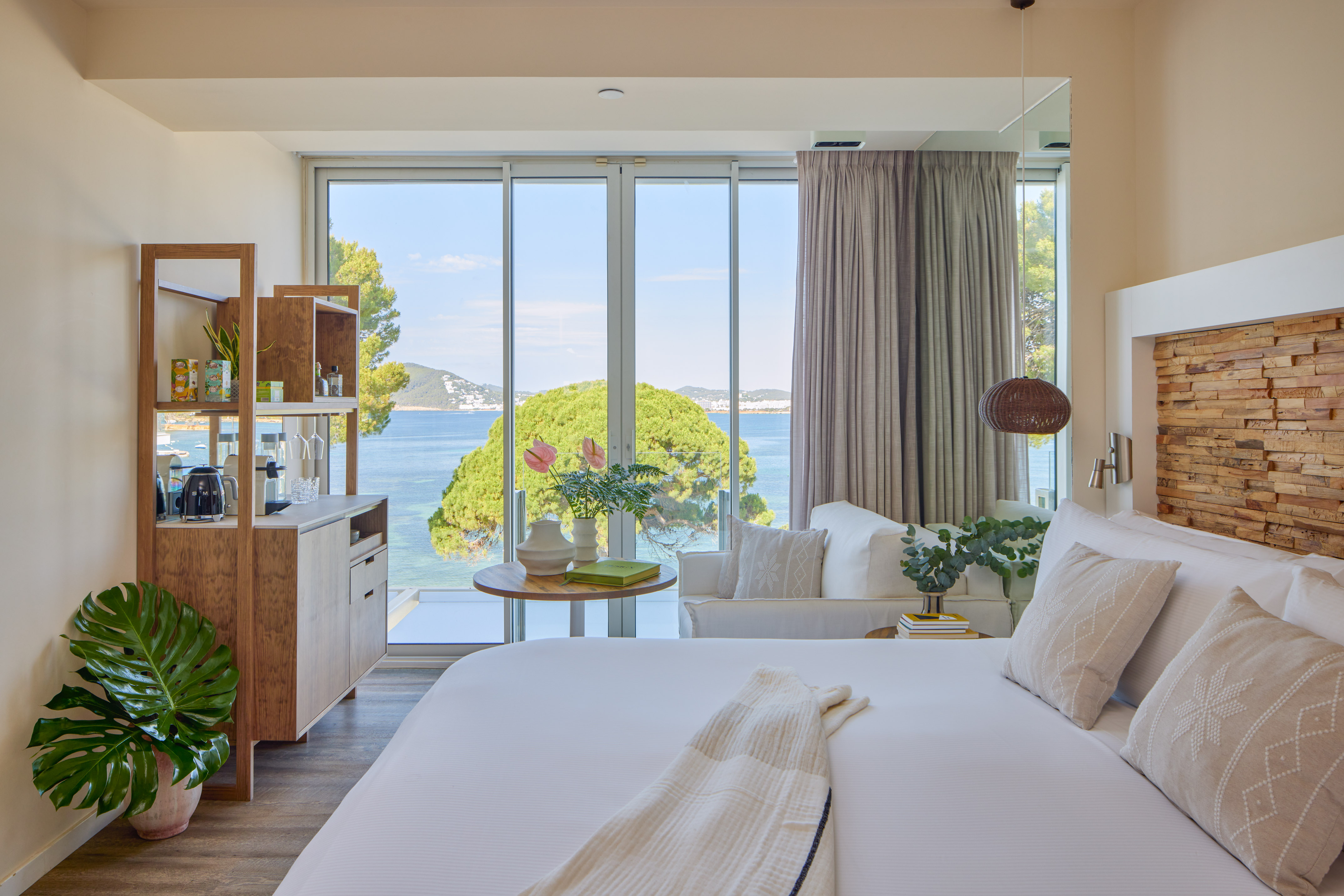 Modern hotel room with stunning sea view, king bed, and contemporary decor.