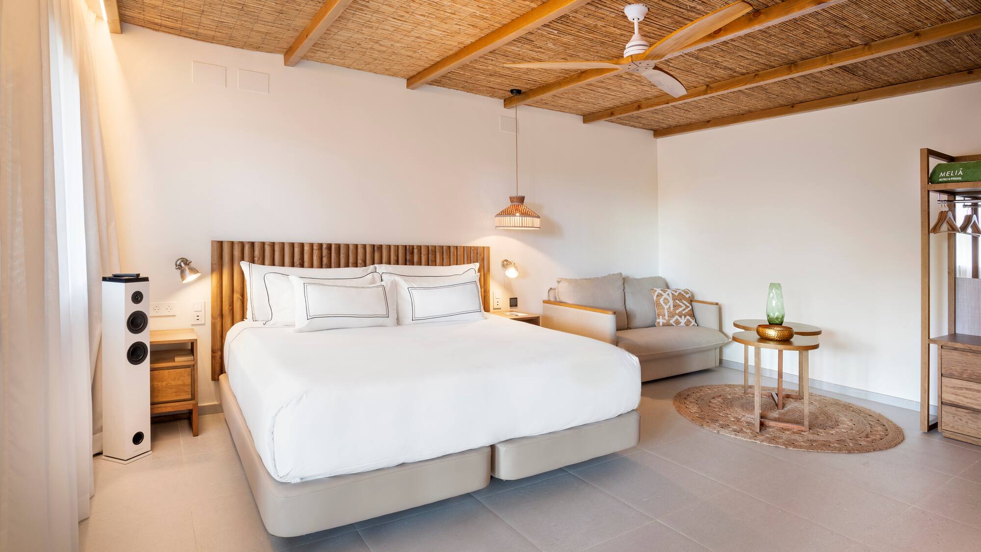 a bedroom with a bed and a couch