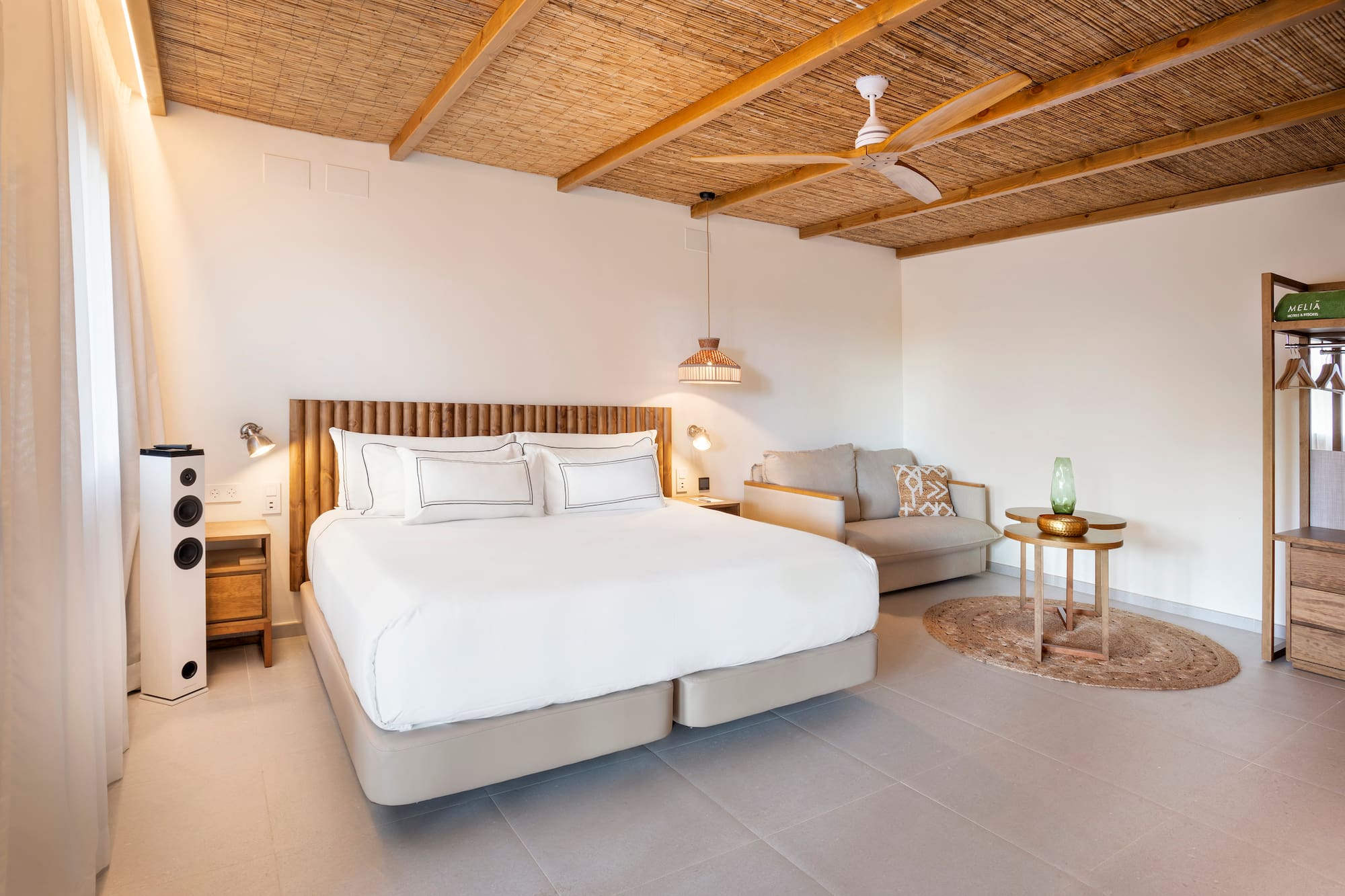 a bedroom with a bed and a couch