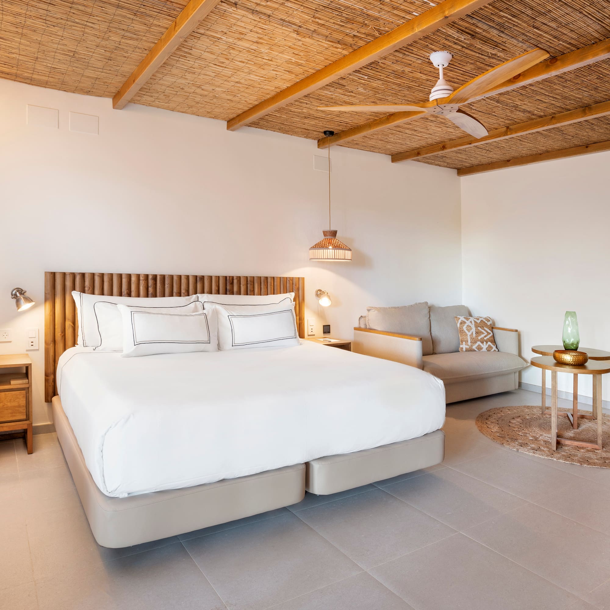 a bedroom with a bed and a couch