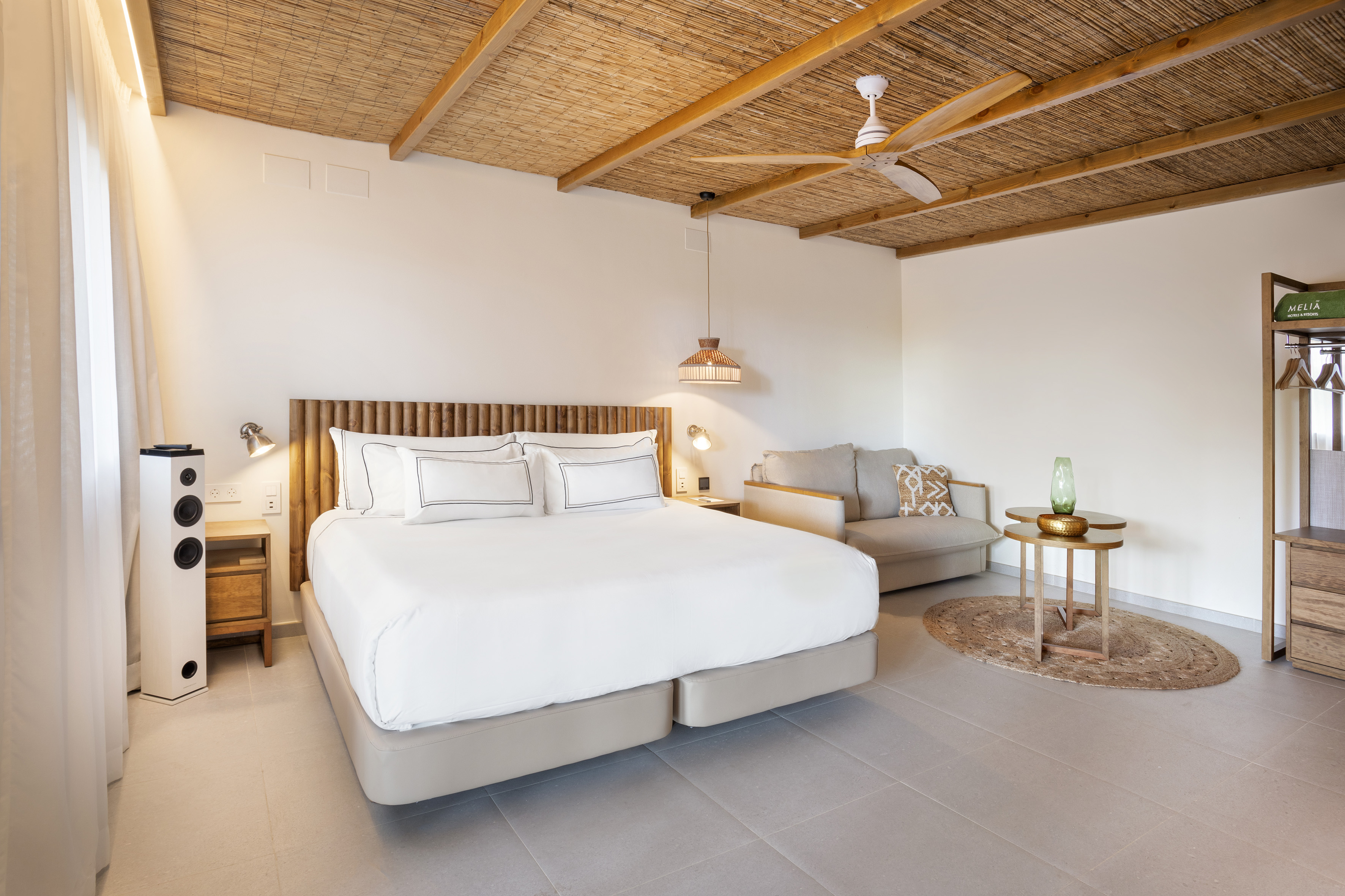 a bedroom with a bed and a couch