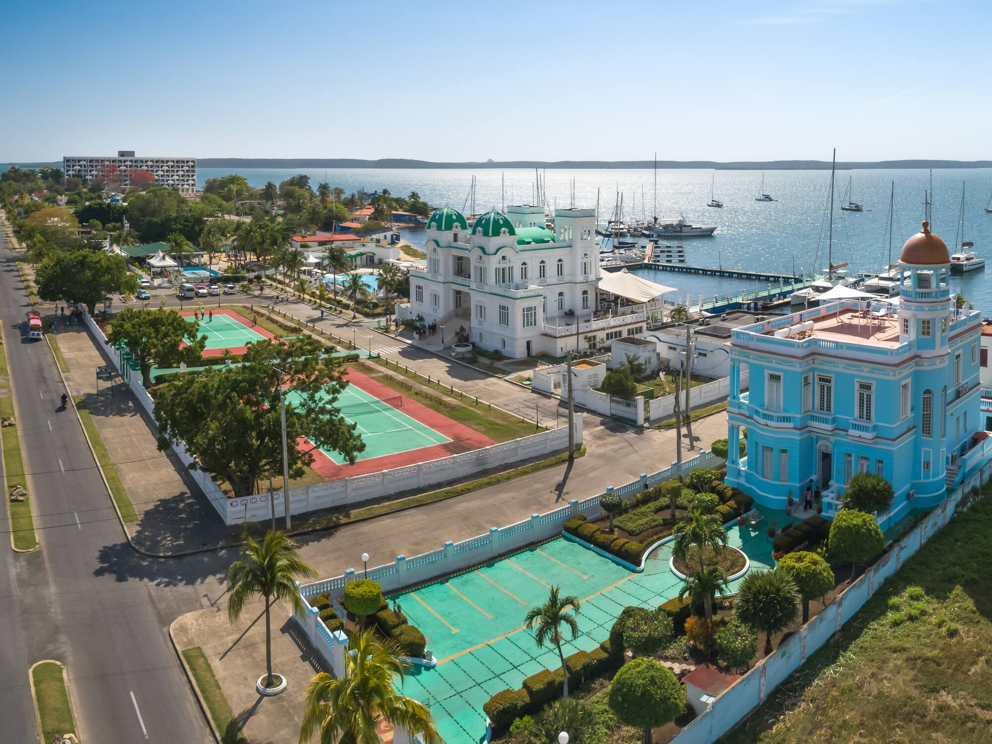 a tennis court and tennis court next to a body of water