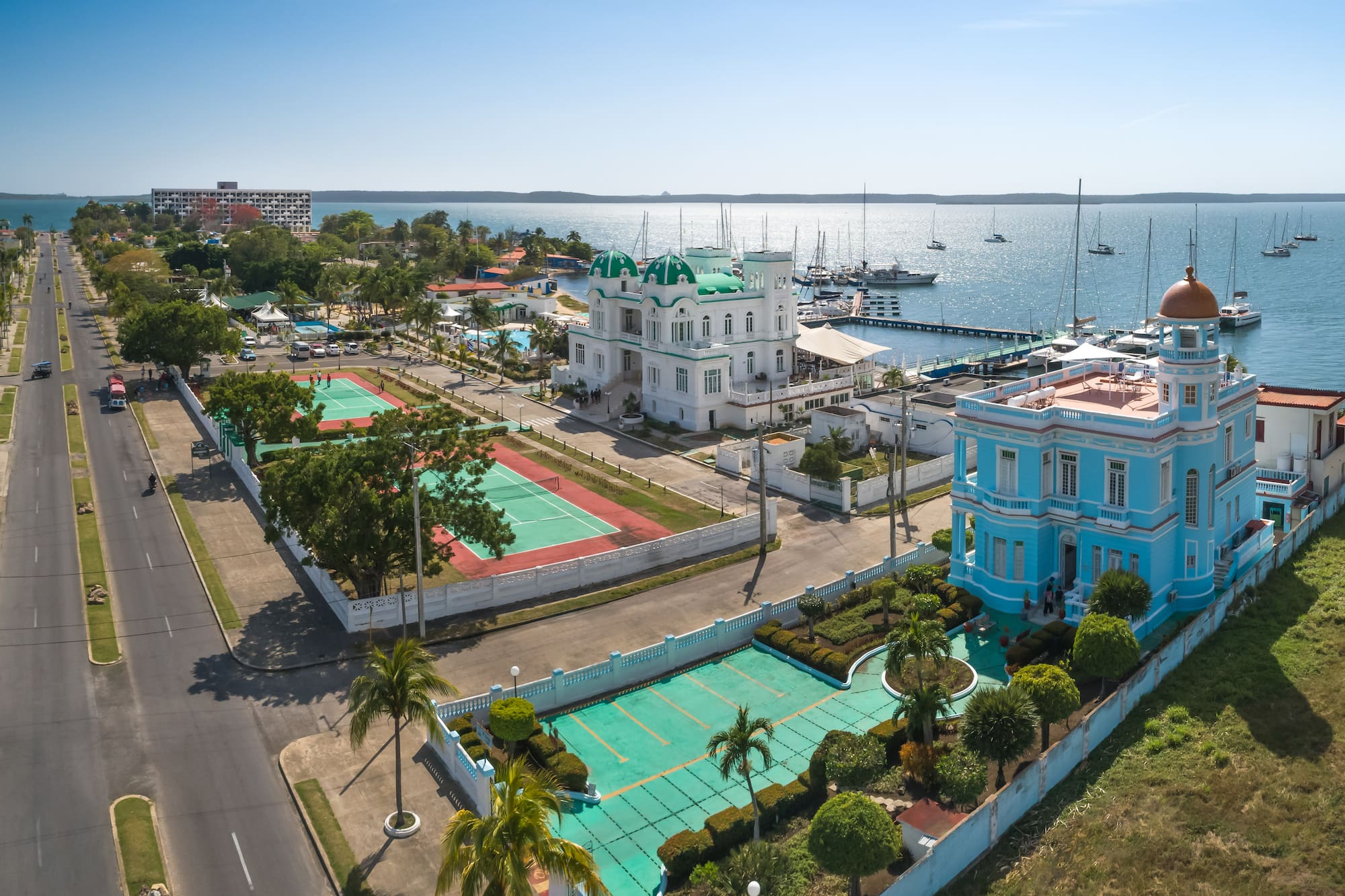 a tennis court and tennis court next to a body of water