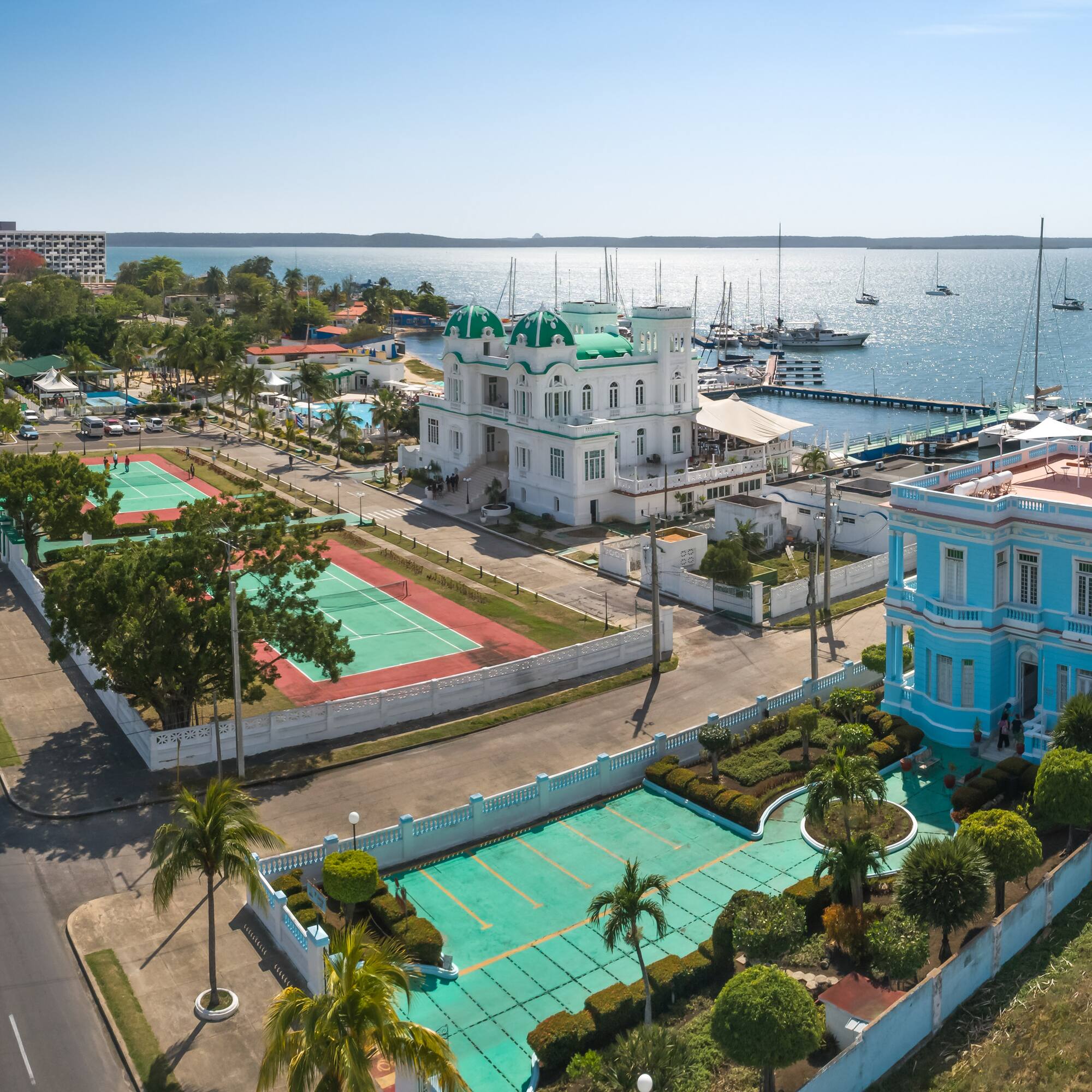 a tennis court and tennis court next to a body of water