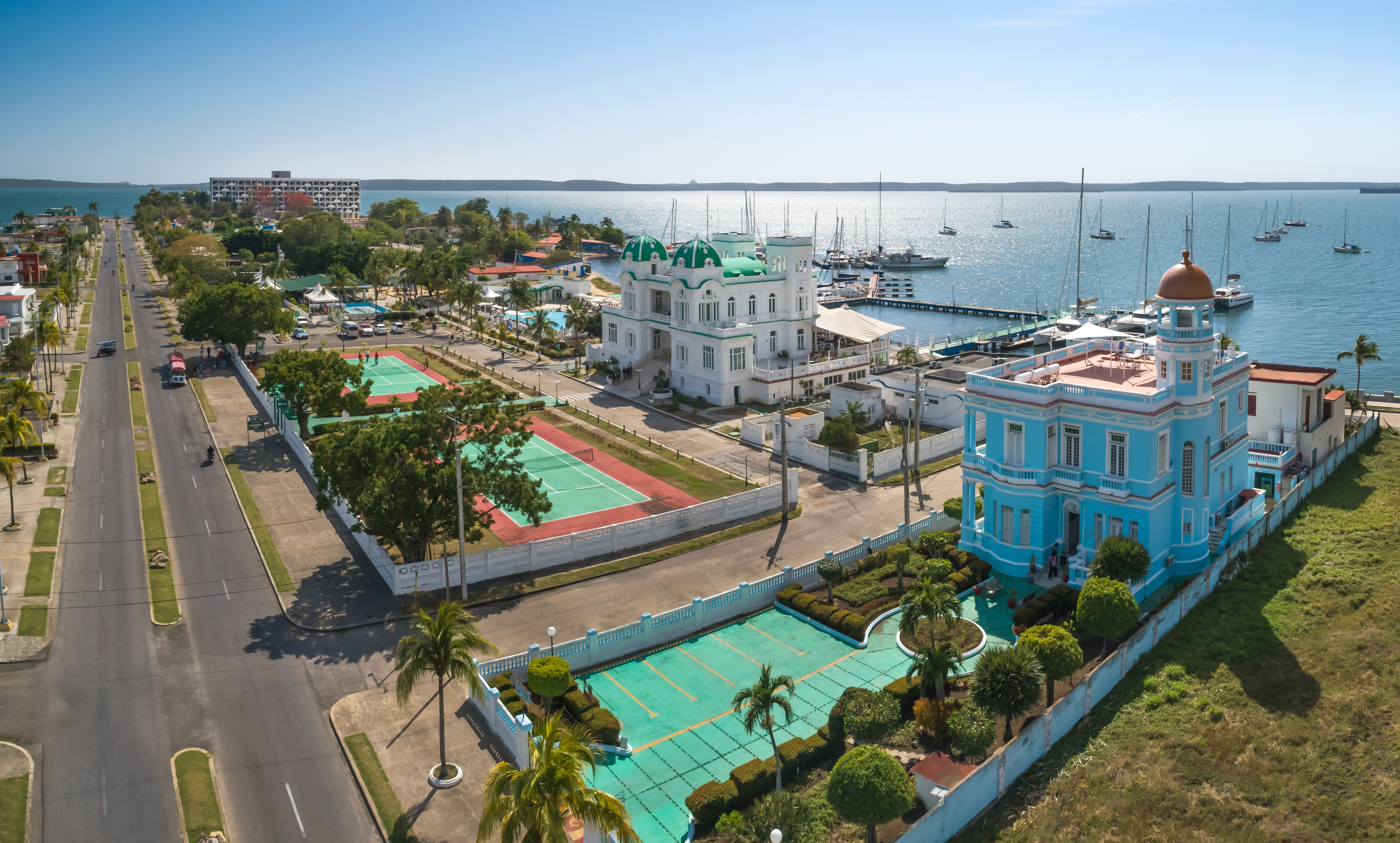 a tennis court and tennis court next to a body of water