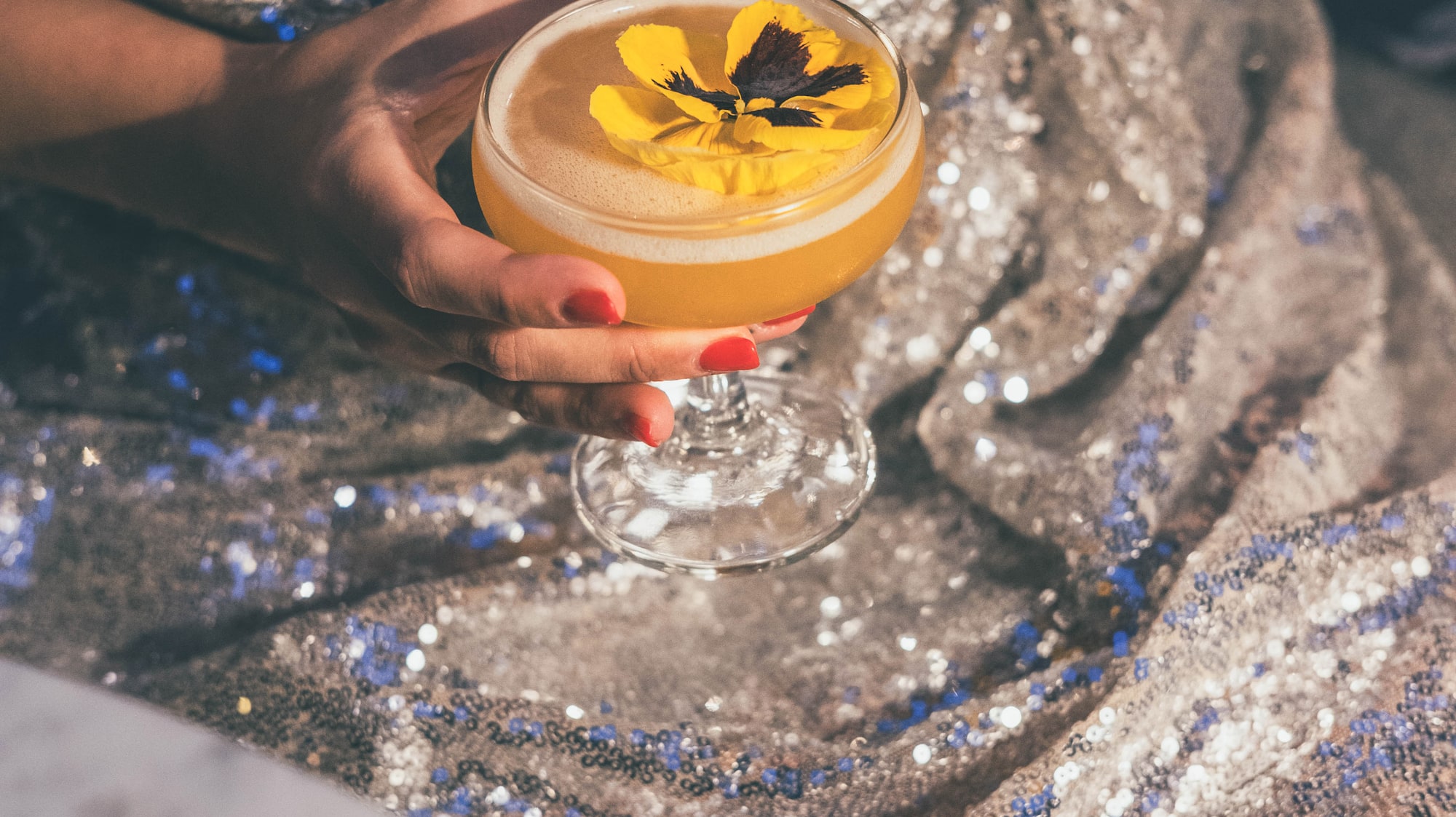 a woman holding a drink