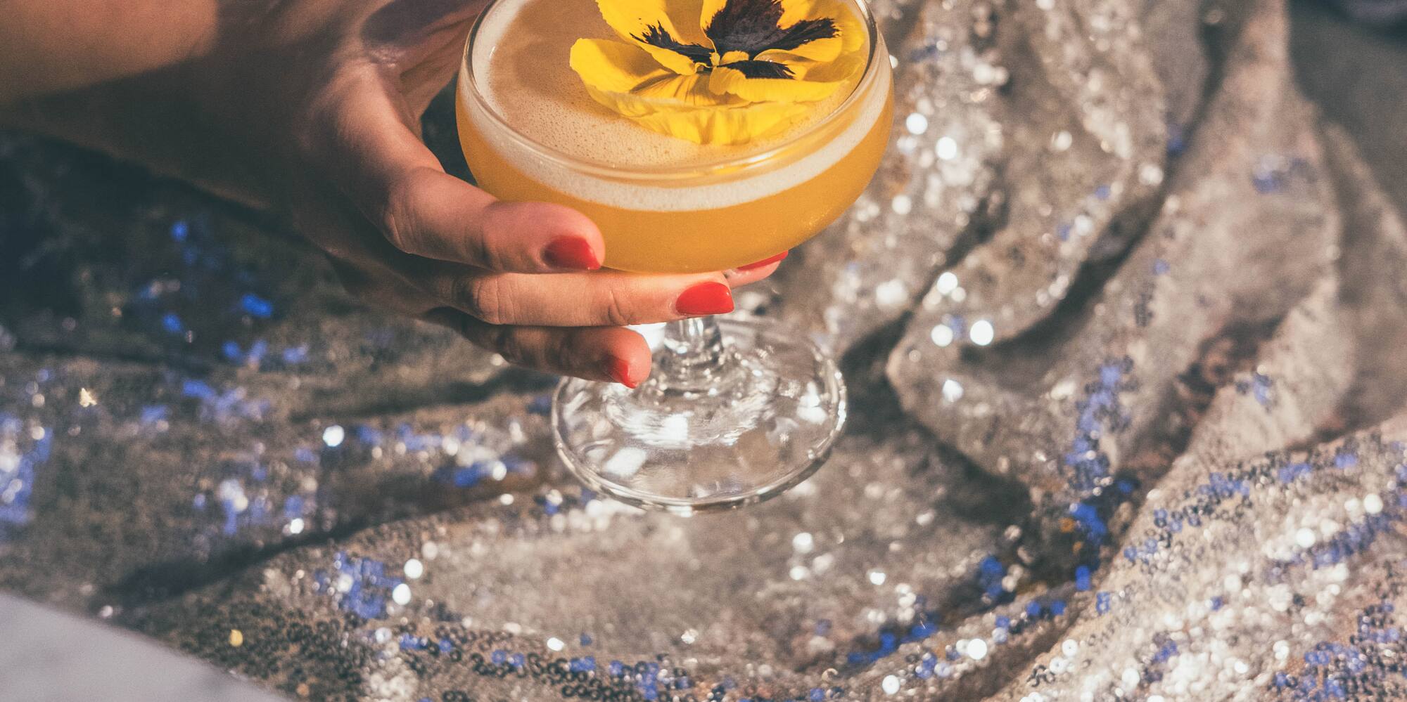 a woman holding a drink