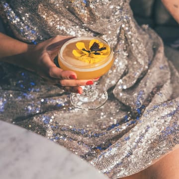 a woman holding a drink