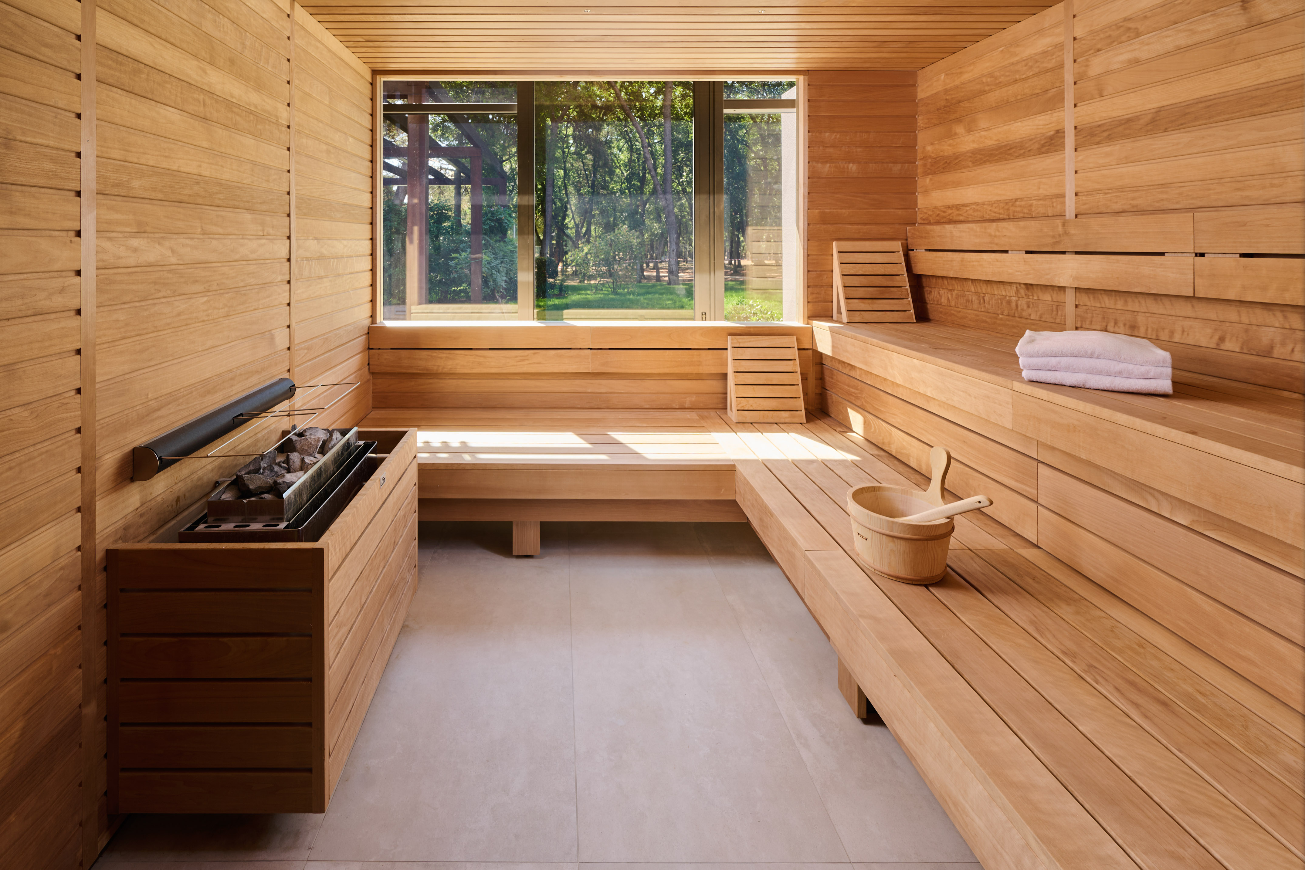 a sauna with a bucket and a fire pit