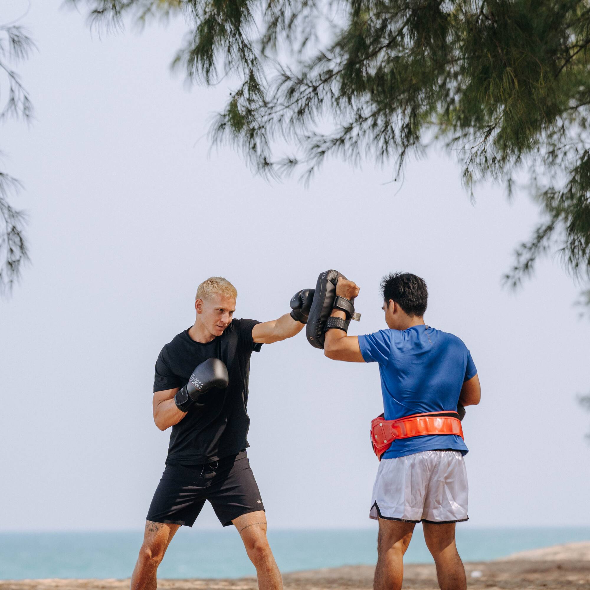 two men boxing on a beach
