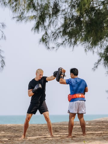 two men boxing on a beach