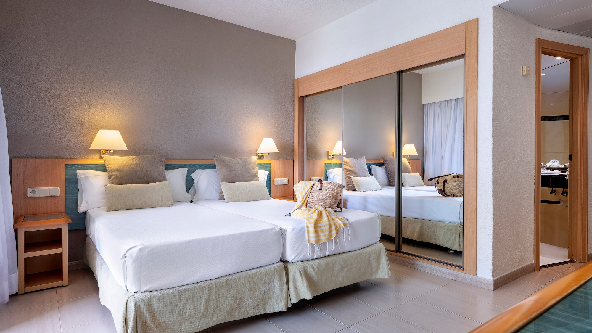 a room with two beds and a mirror