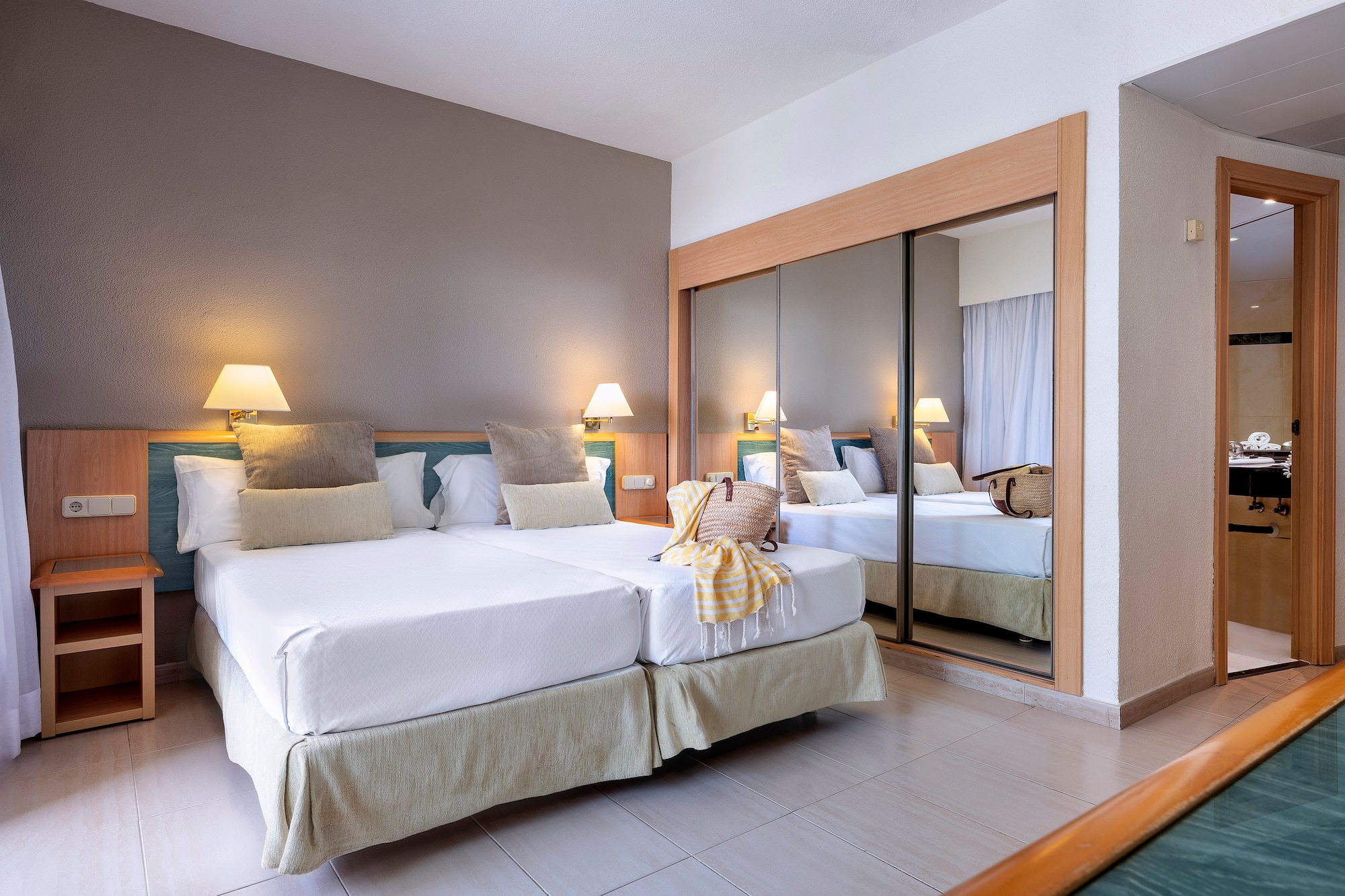 a room with two beds and a mirror