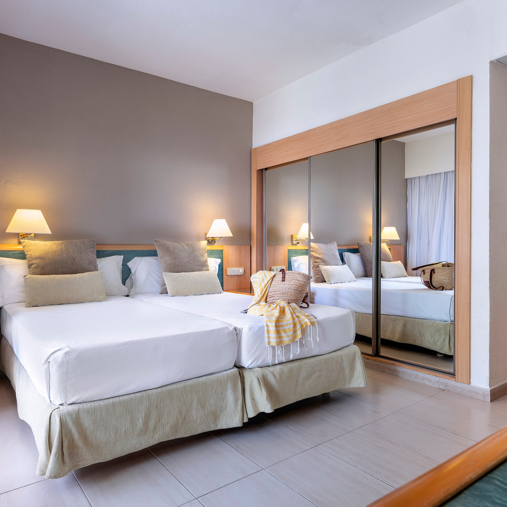 a room with two beds and a mirror