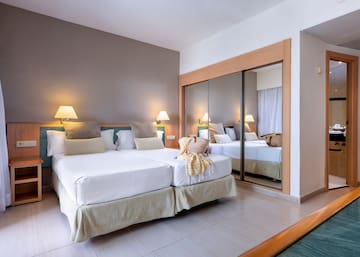 a room with two beds and a mirror