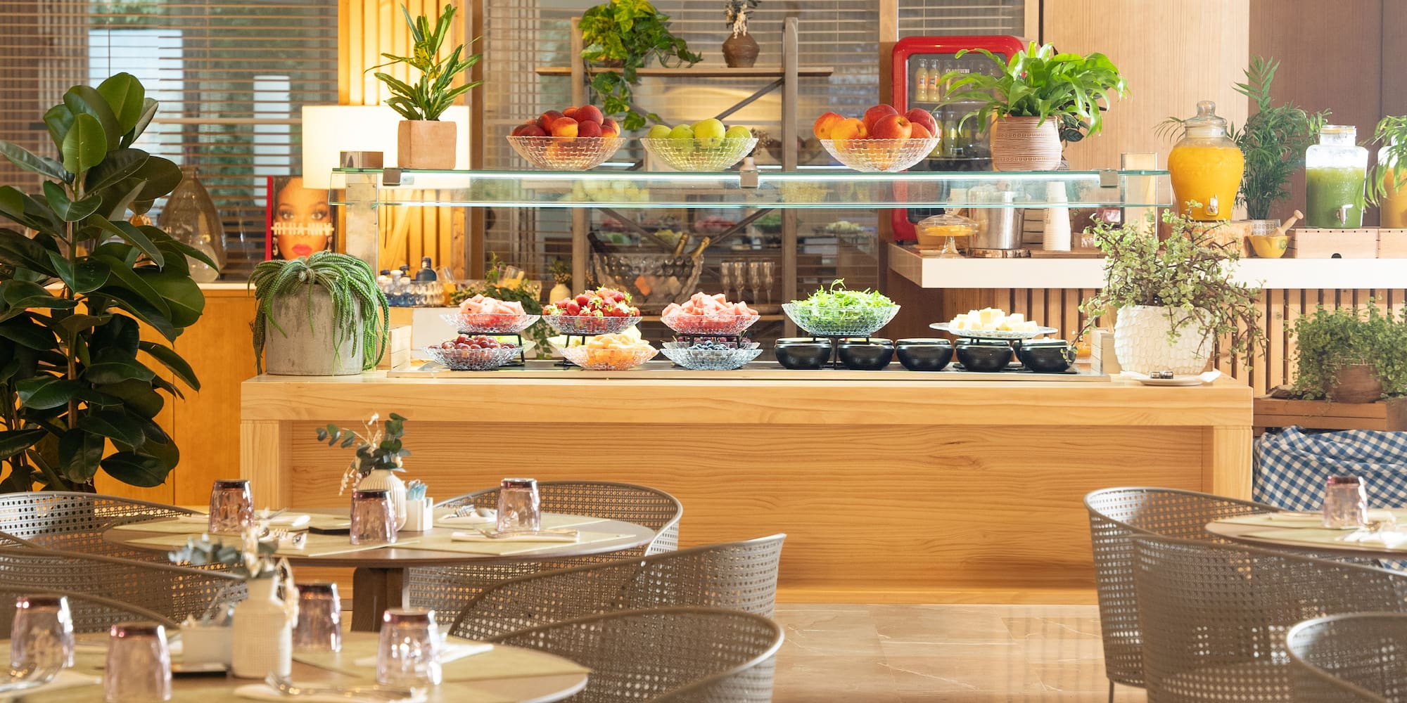 a buffet with a glass shelf and a variety of food on it