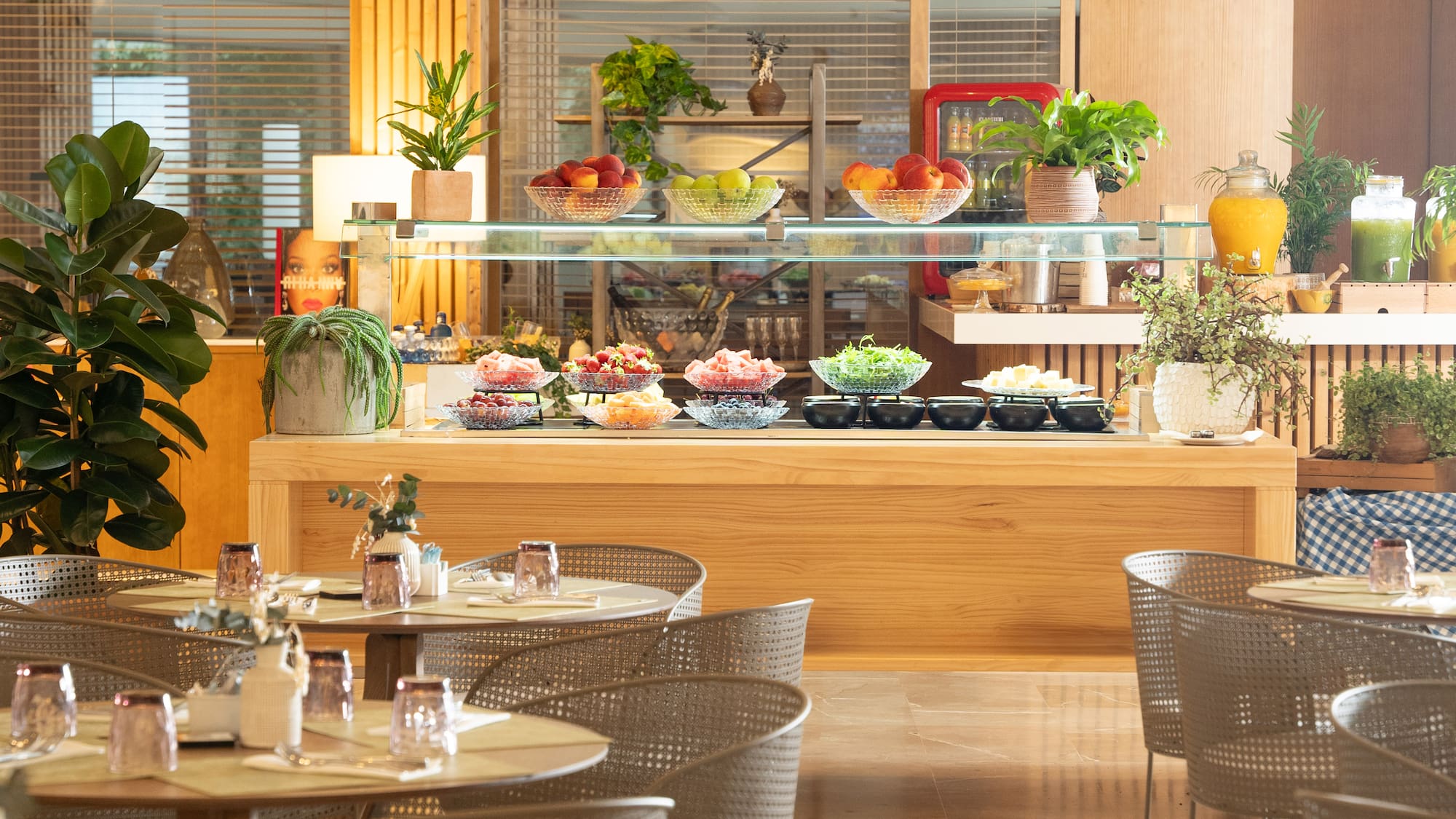 a buffet with a glass shelf and a variety of food on it